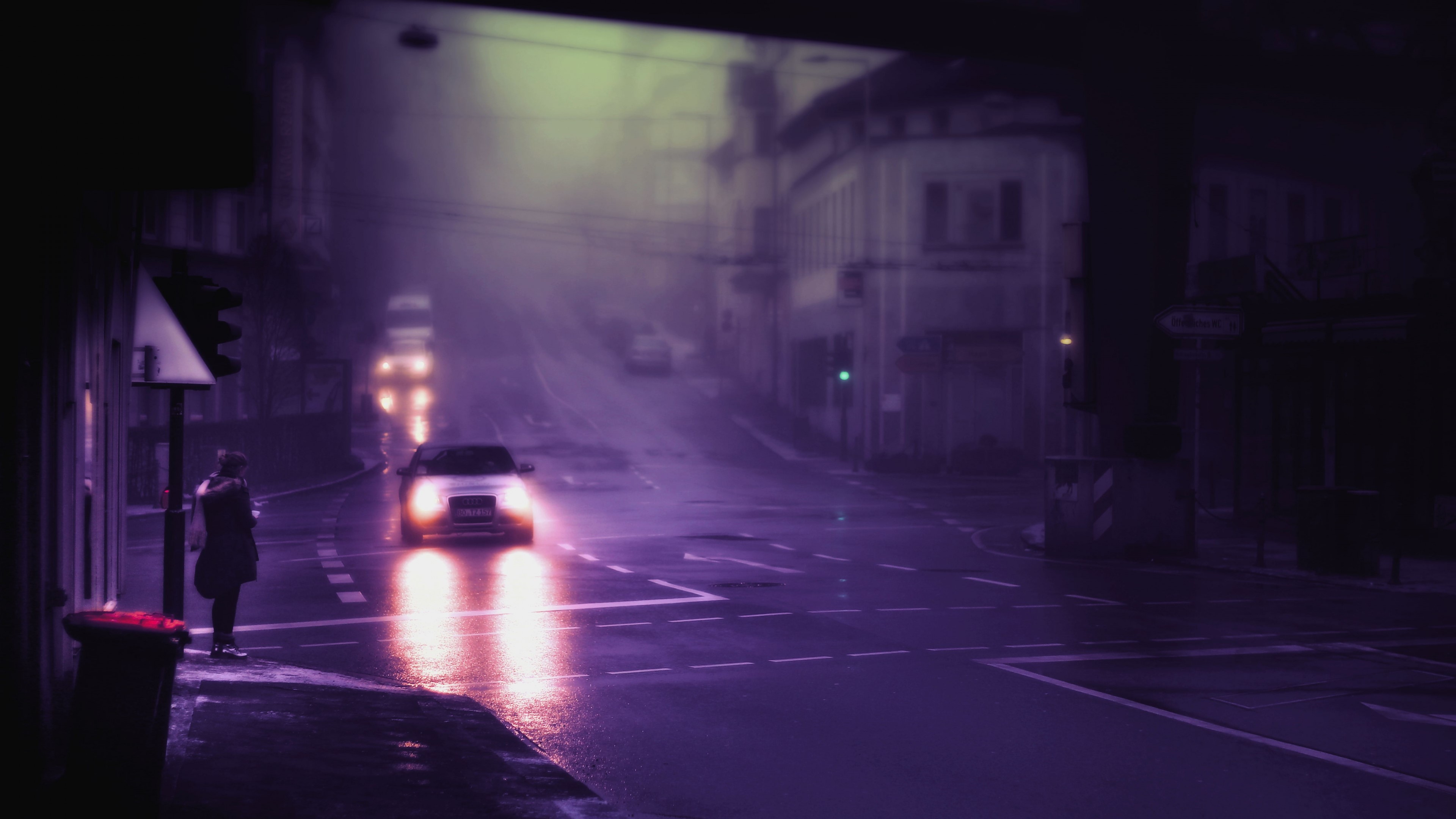 Car driving through foggy city street at night HD Wallpaper