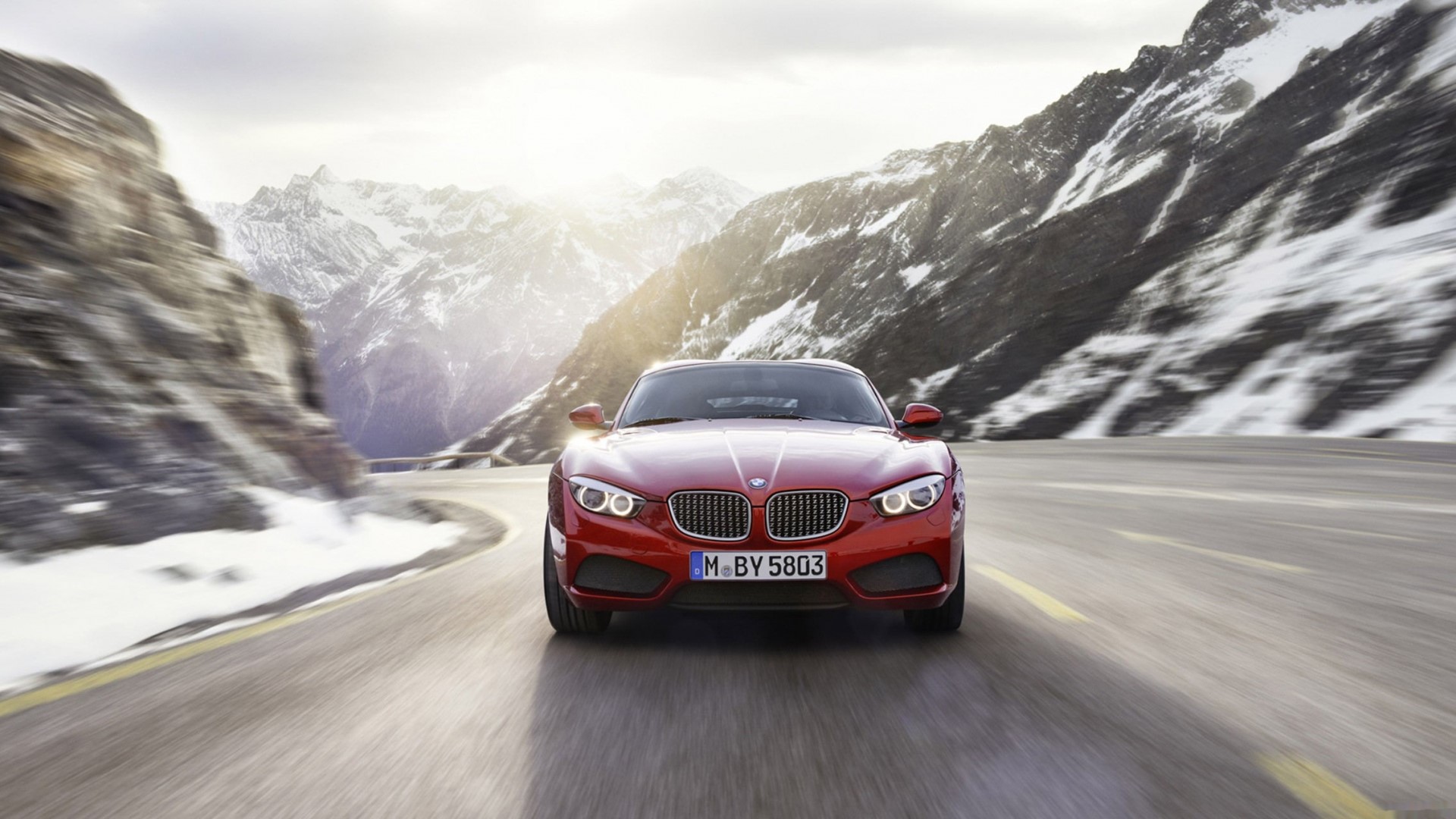 Red BMW car on a mountain road HD Wallpaper