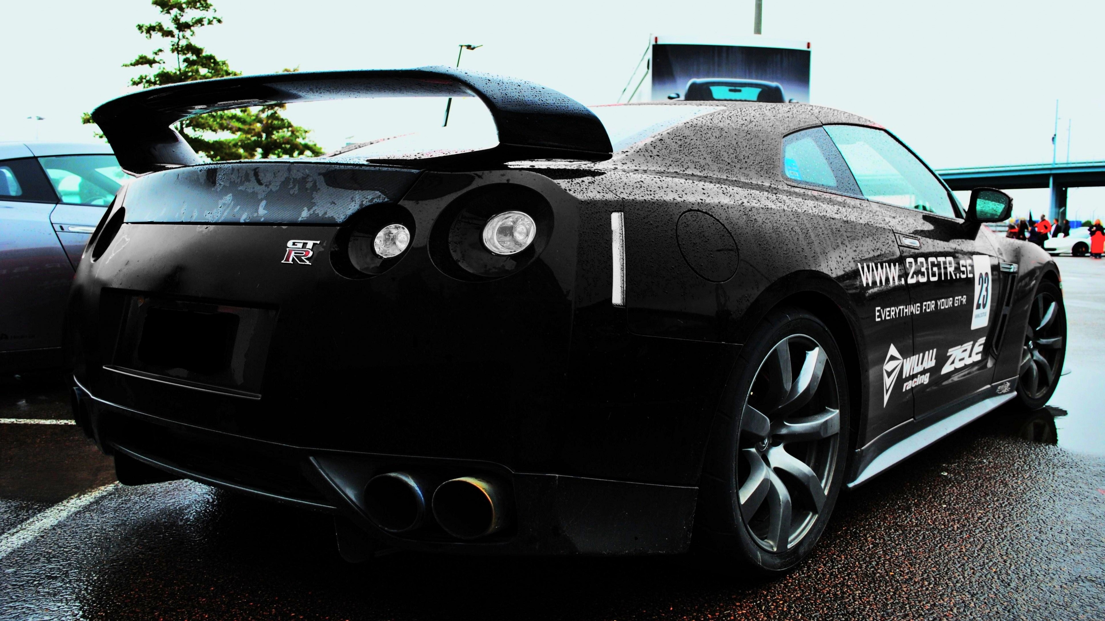 Black Nissan GT-R with racing decals HD Wallpaper