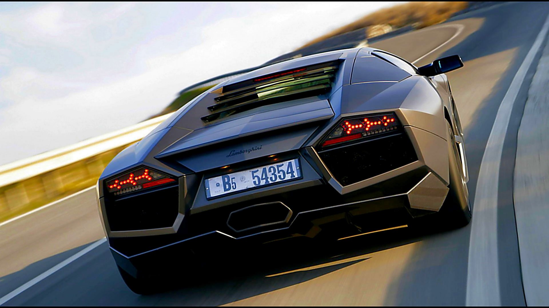 Lamborghini Reventon driving on a winding road HD Wallpaper