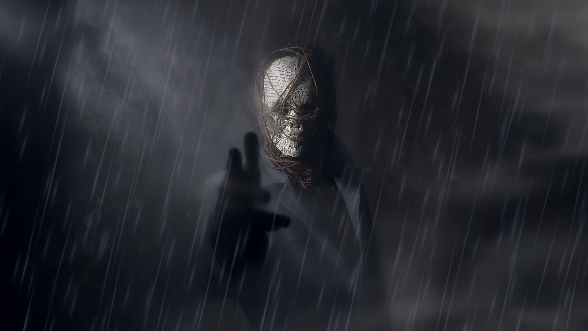 A figure with a book-covered face in the rain HD Wallpaper