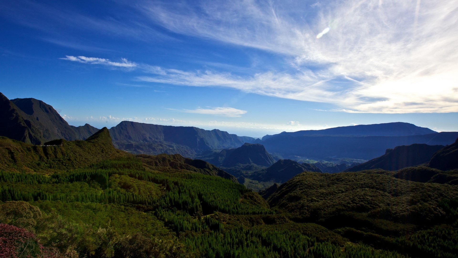 Mountains and valleys under a blue sky HD Wallpaper