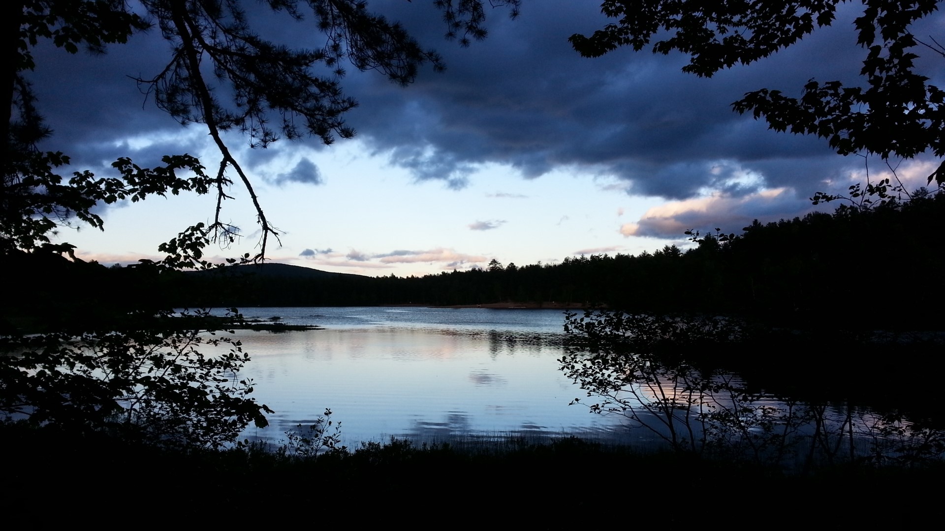 Lake at dusk with dark clouds HD Wallpaper