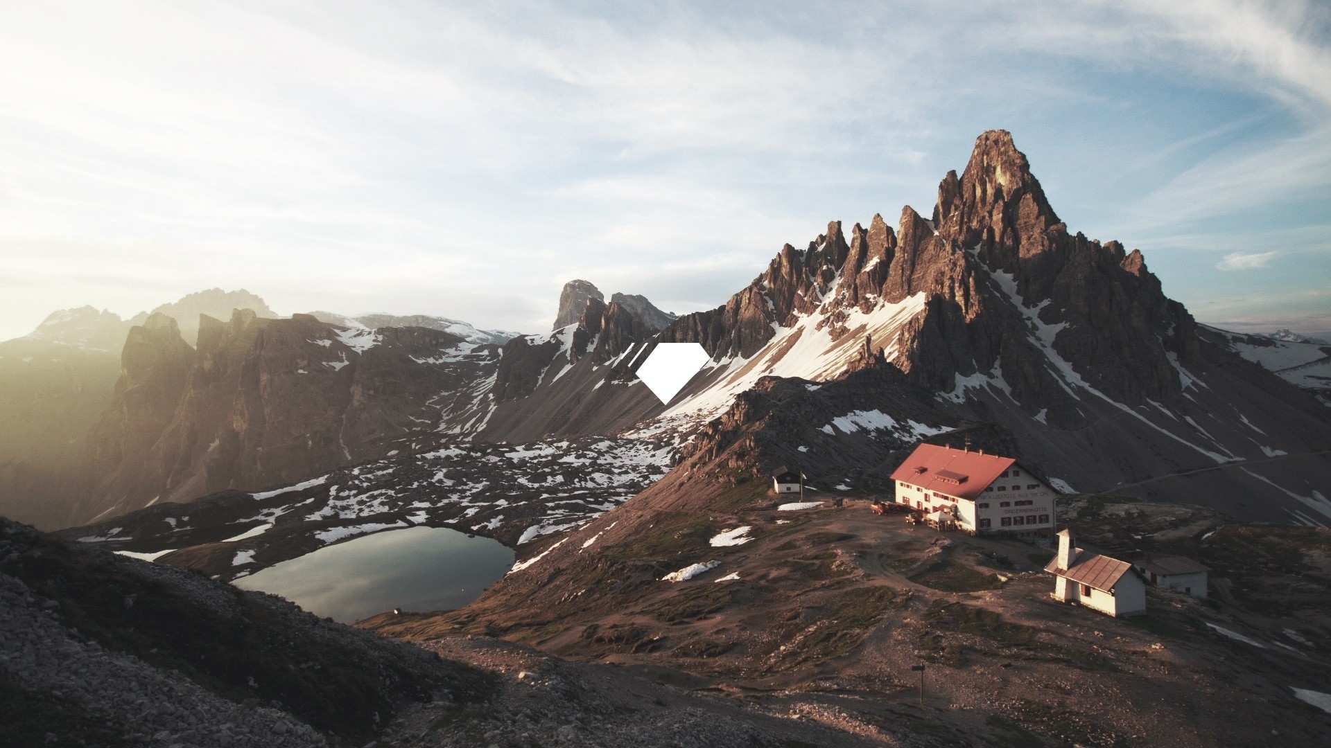 Mountain range with snow and a lake HD Wallpaper