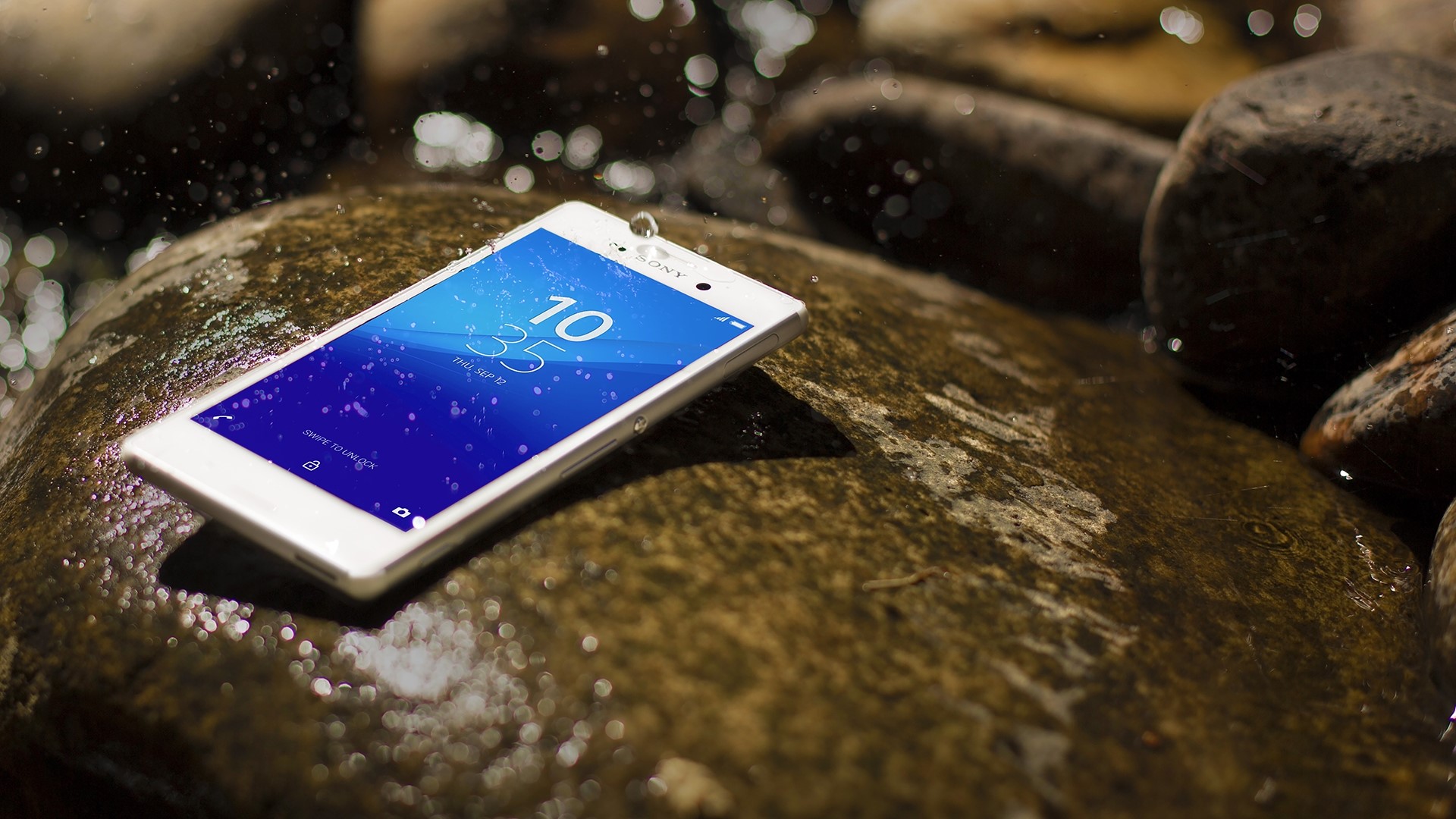 Sony Xperia M4 Aqua phone on wet rocks HD Wallpaper