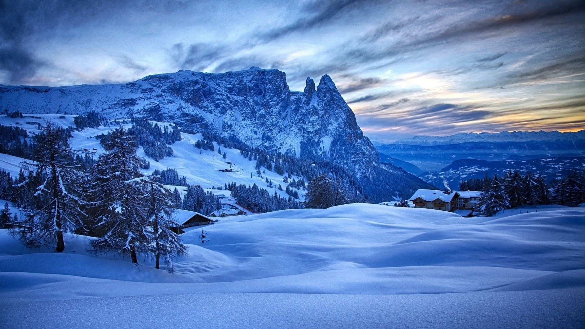 Snowy mountain landscape with houses and trees HD Wallpaper