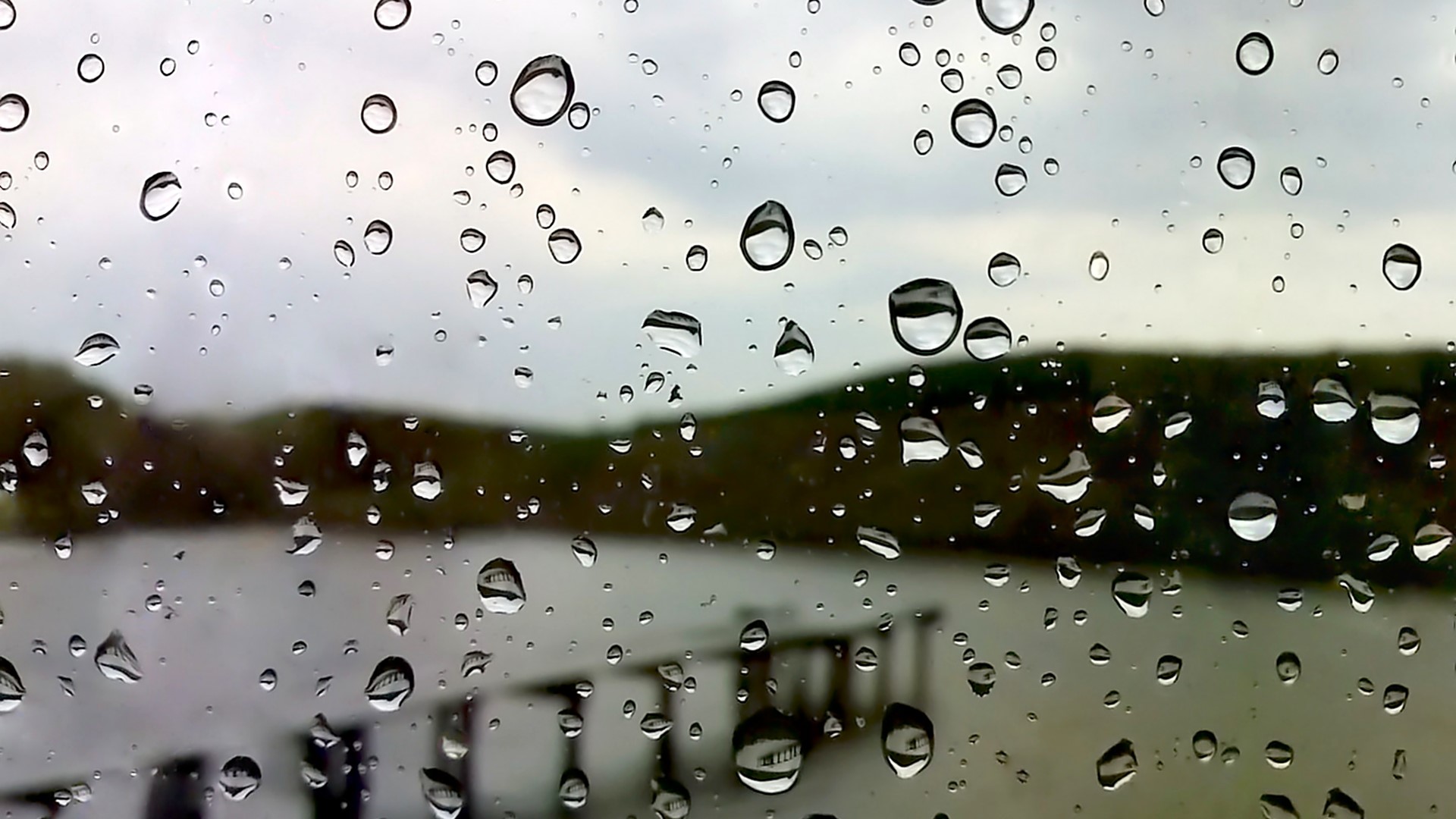 Raindrops on glass with blurred background HD Wallpaper
