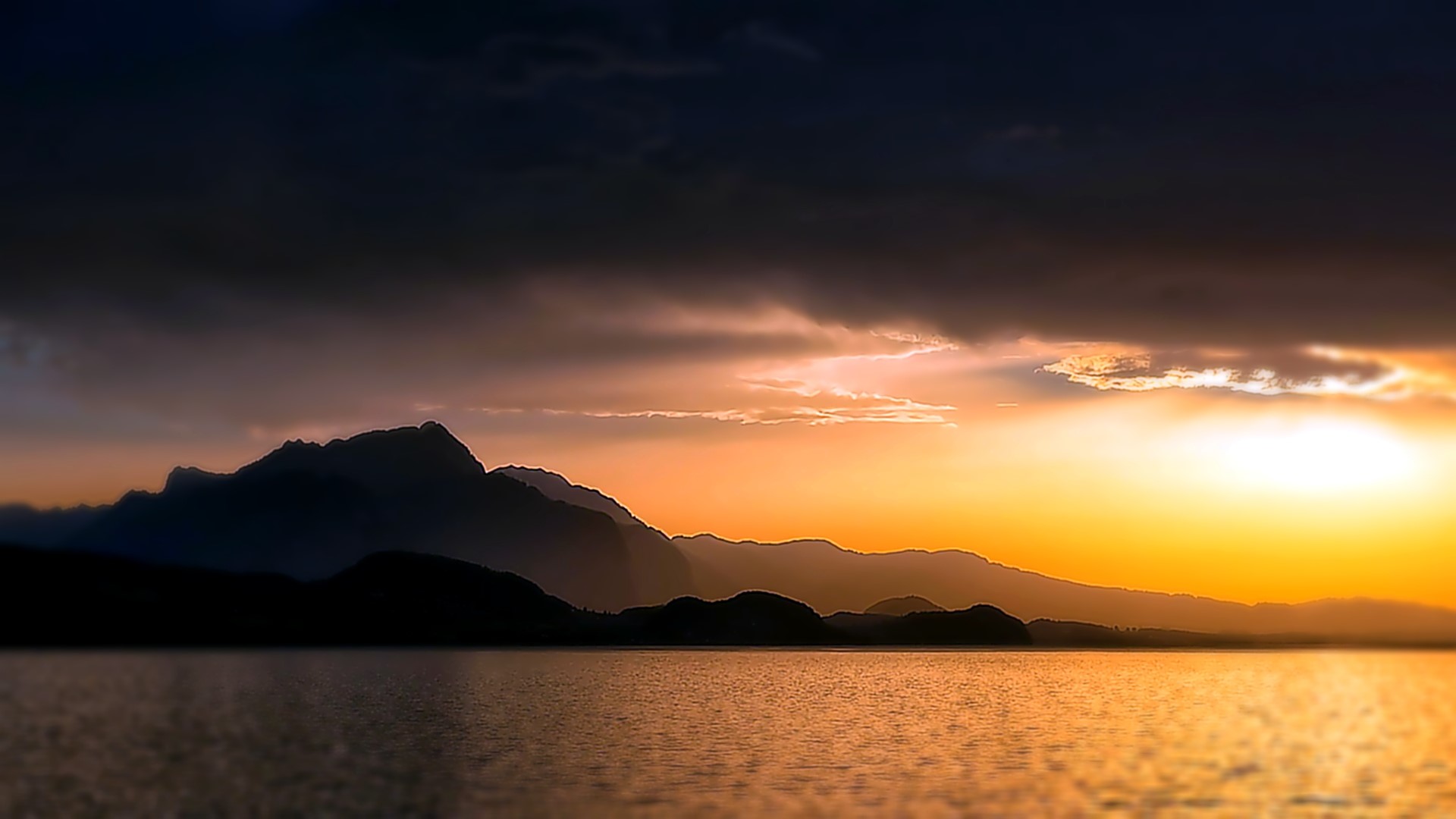 Sunset over mountains and lake with clouds HD Wallpaper