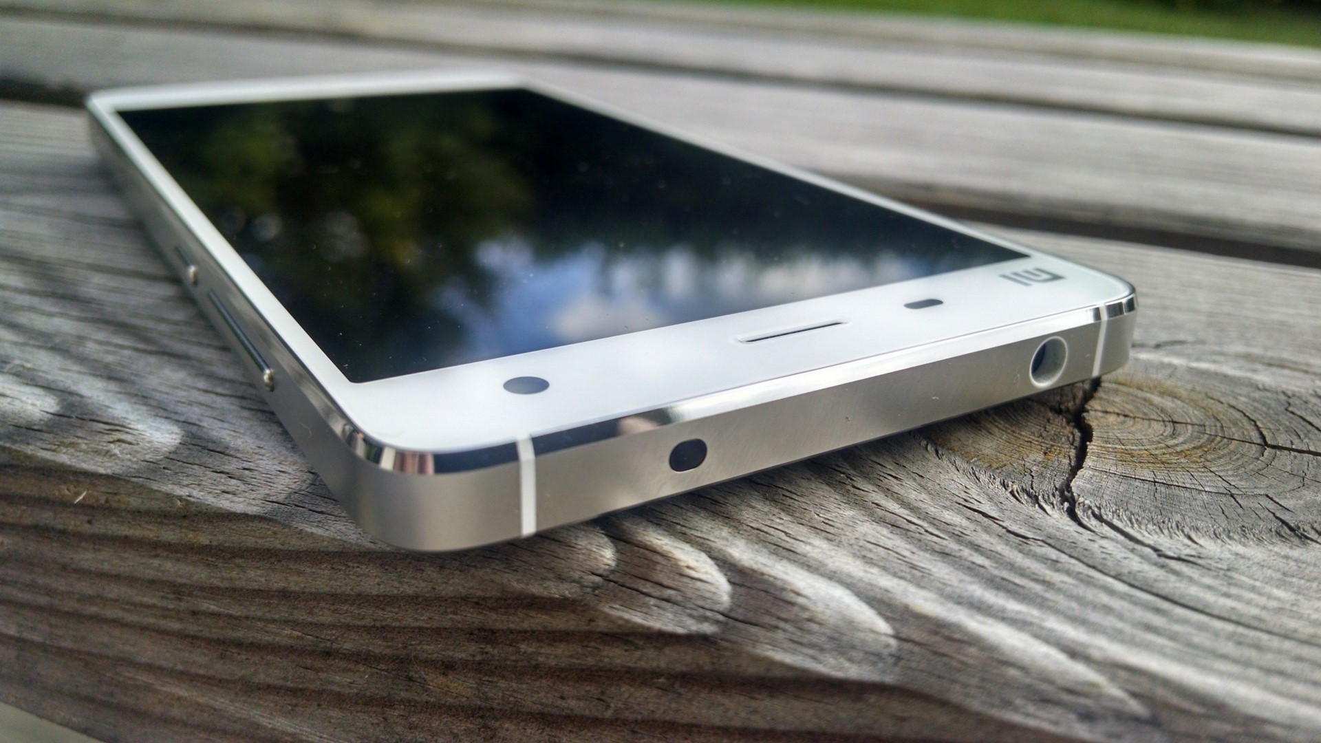 Xiaomi smartphone on a wooden surface HD Wallpaper