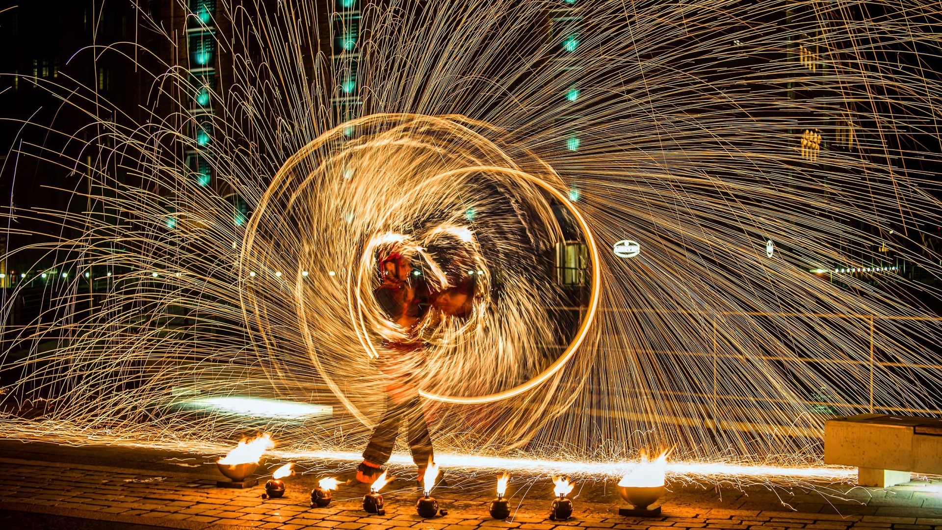Man performing fire spinning with sparks HD Wallpaper