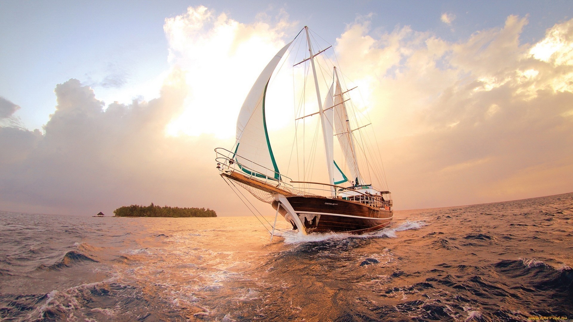 Sailboat sailing on the ocean near an island at sunset HD Wallpaper