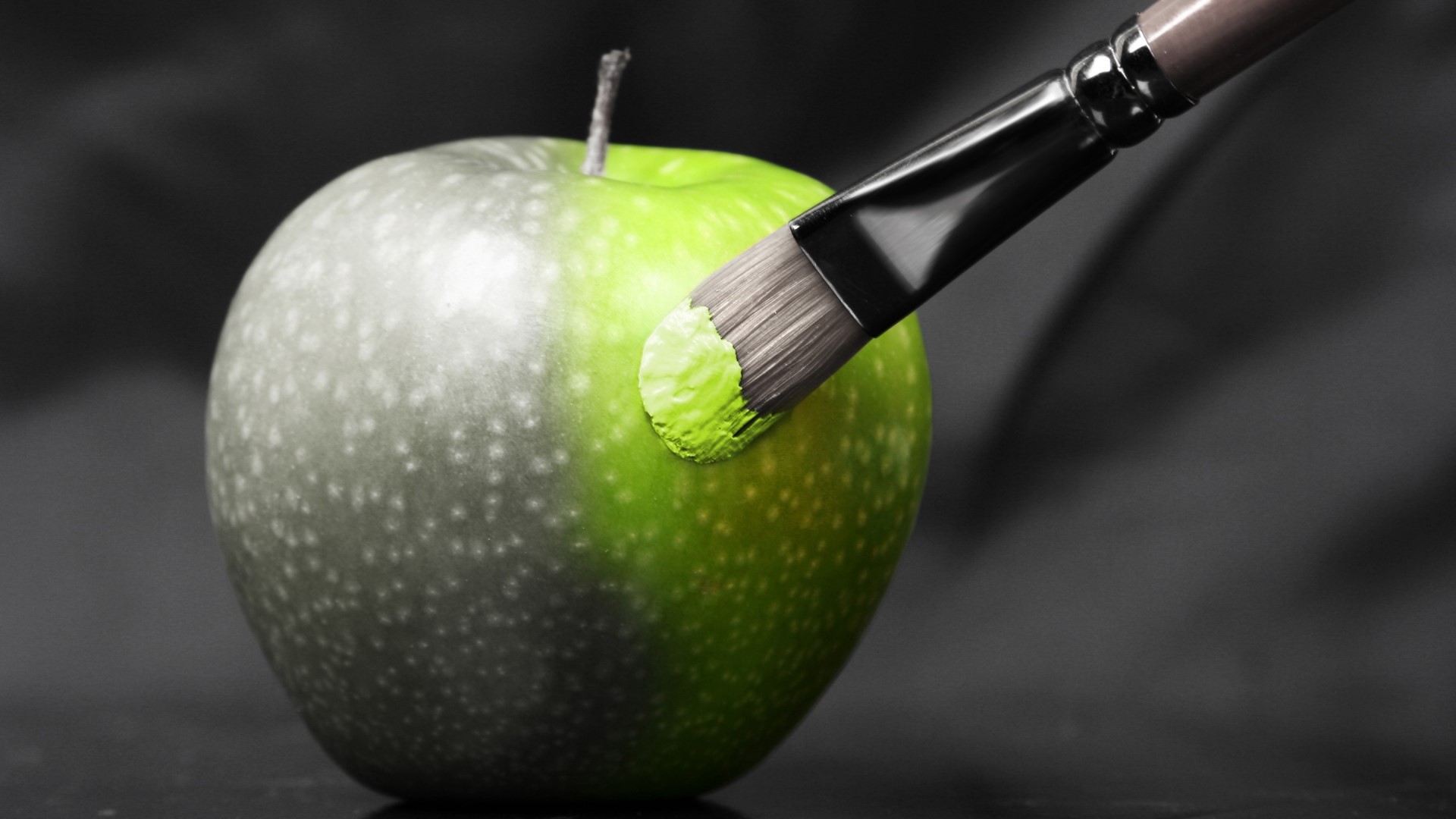 Painting a grey apple green with a paintbrush HD Wallpaper