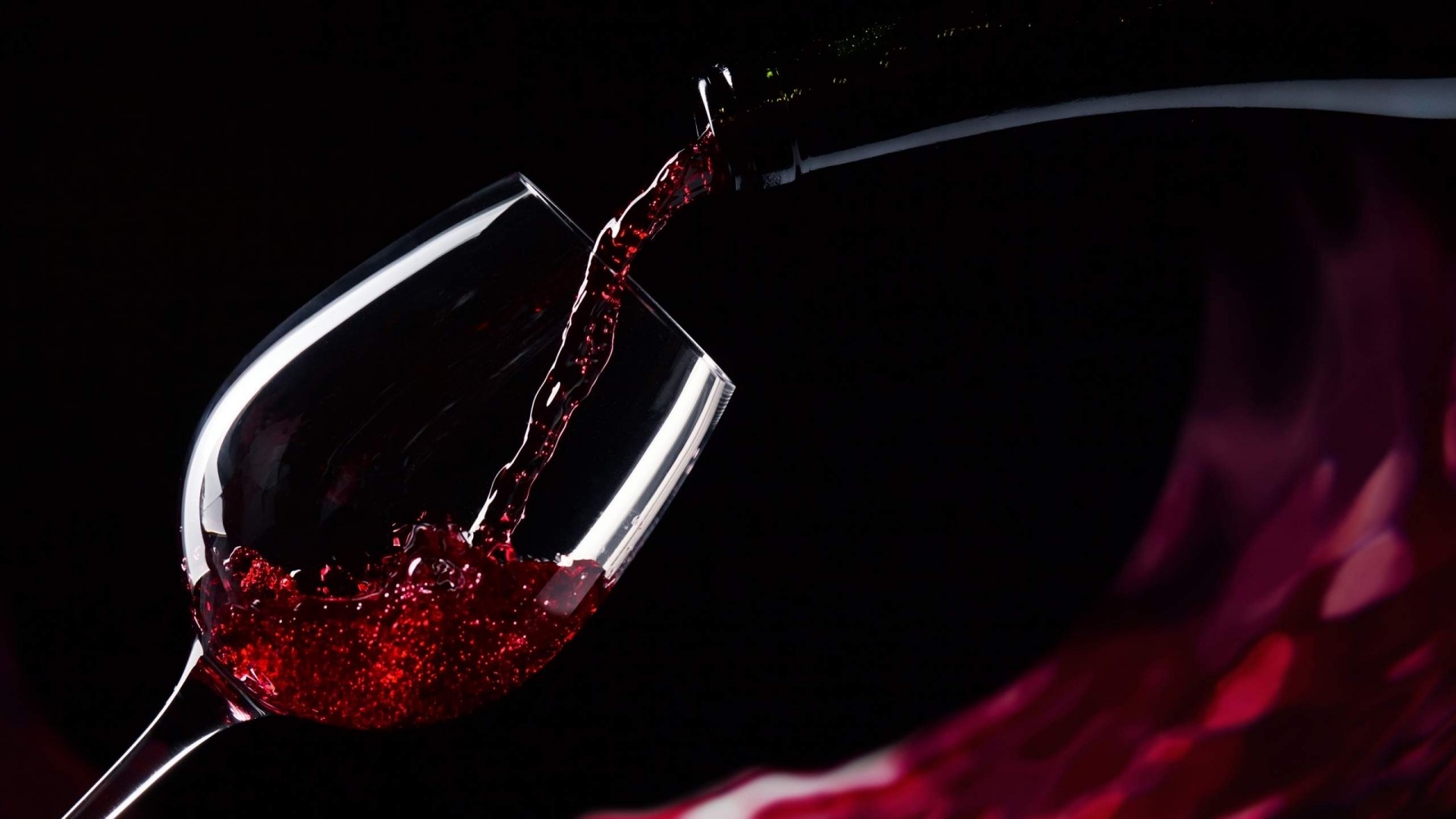 Red wine being poured from a bottle into a glass HD Wallpaper
