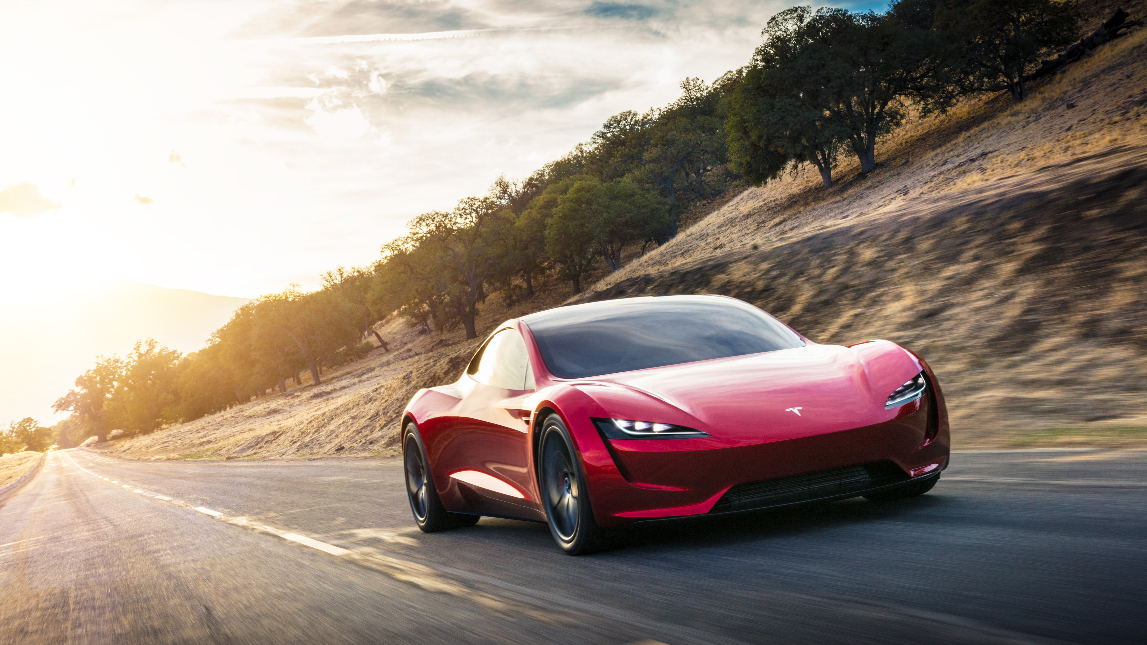 4K Tesla Roadster driving on a road HD Wallpaper