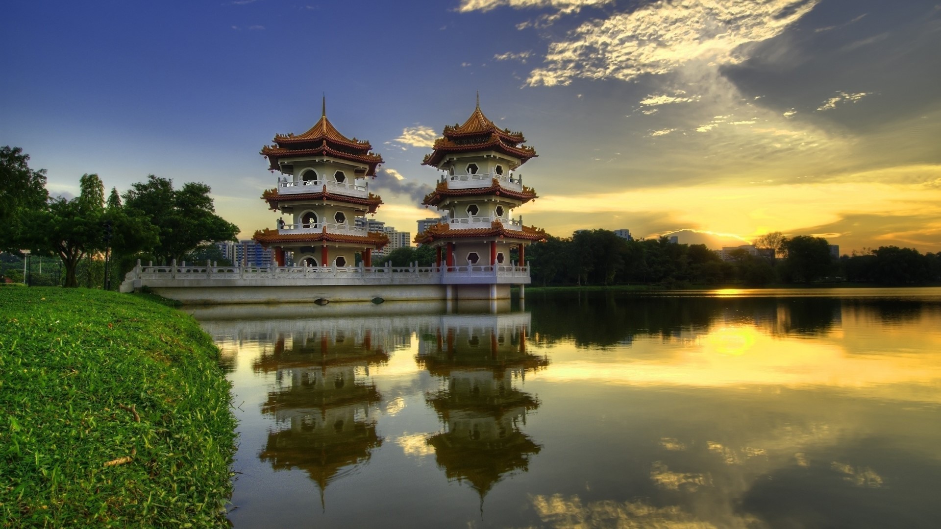 Twin Pagodas Reflected in Water at Sunset HD Wallpaper