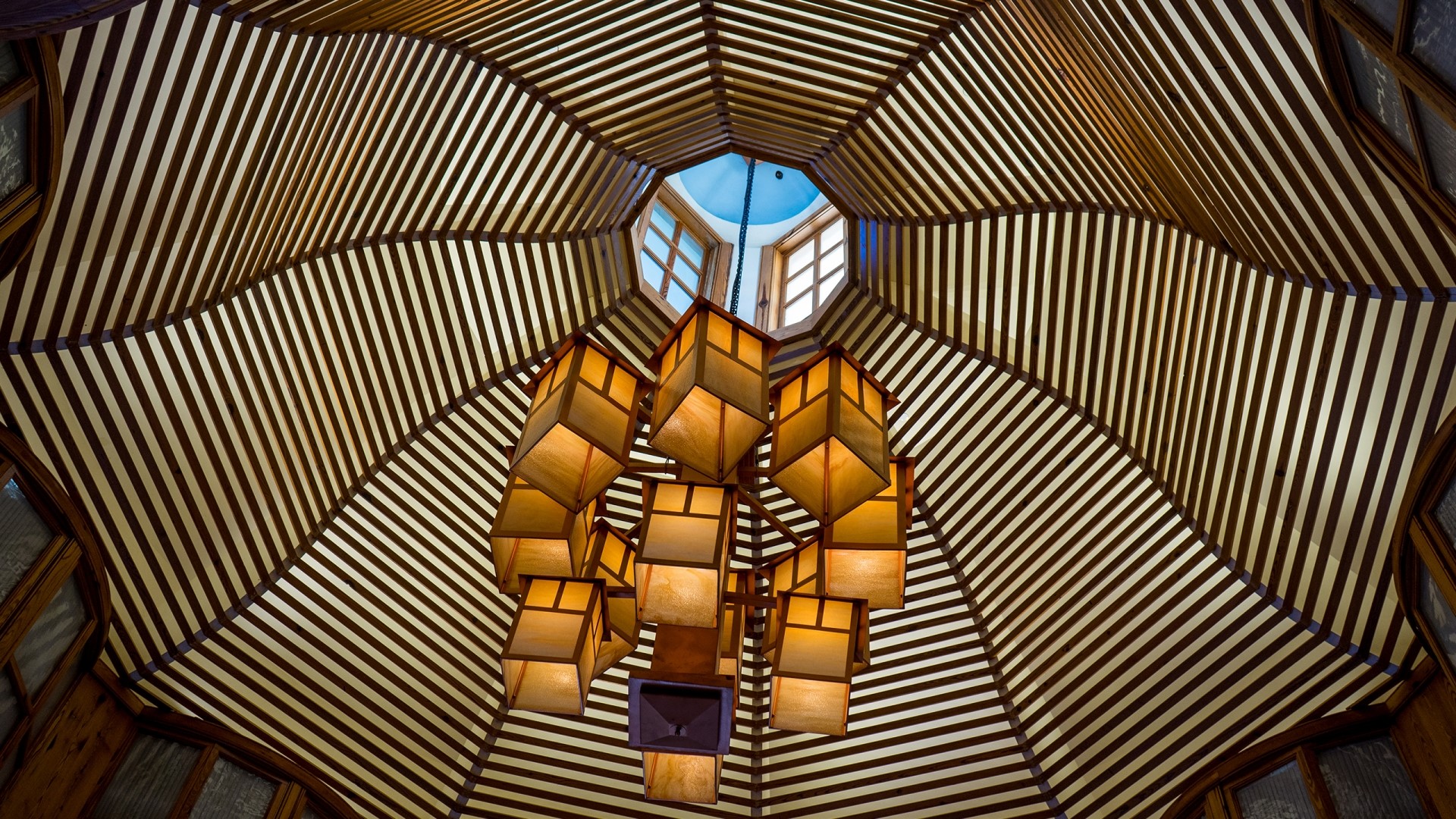 Intricate wooden ceiling with a modern chandelier HD Wallpaper