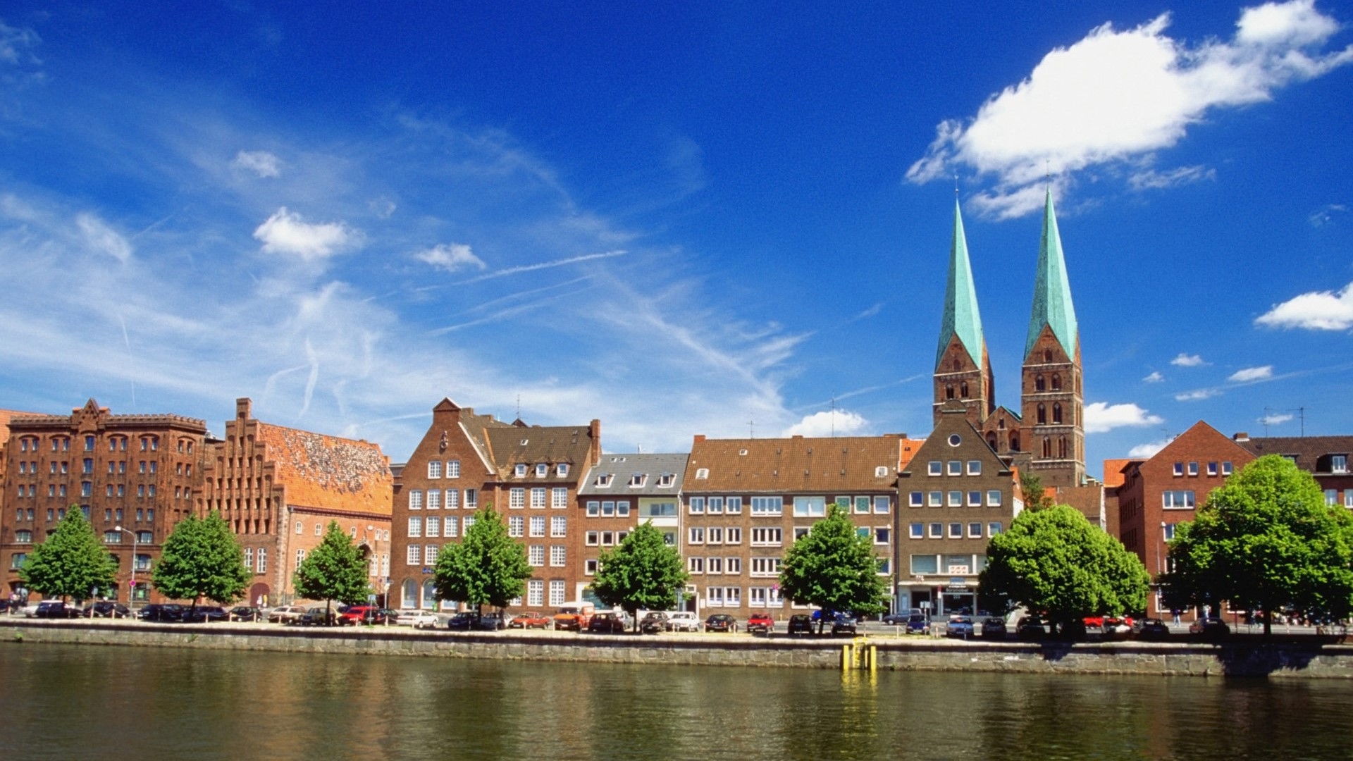 Riverfront buildings and churches in Lubeck, Germany HD Wallpaper
