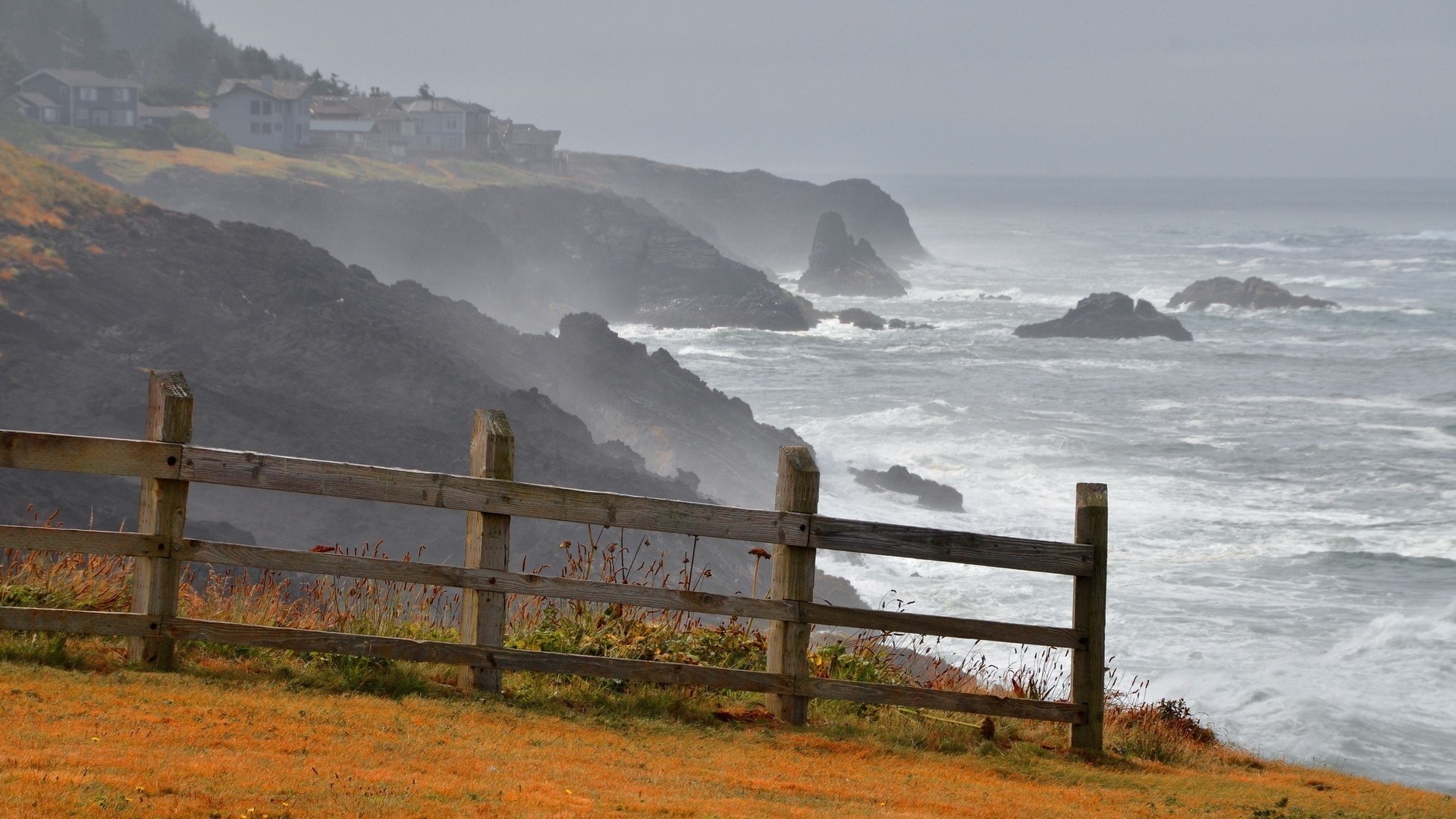 Coastal homes on a cliff overlooking the sea HD Wallpaper