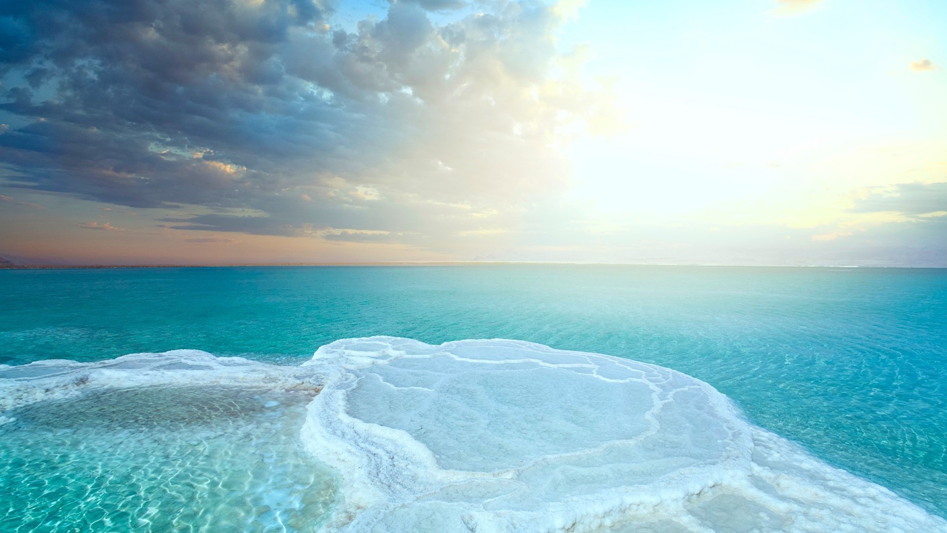 Salt formations on the Dead Sea under a cloudy sky HD Wallpaper