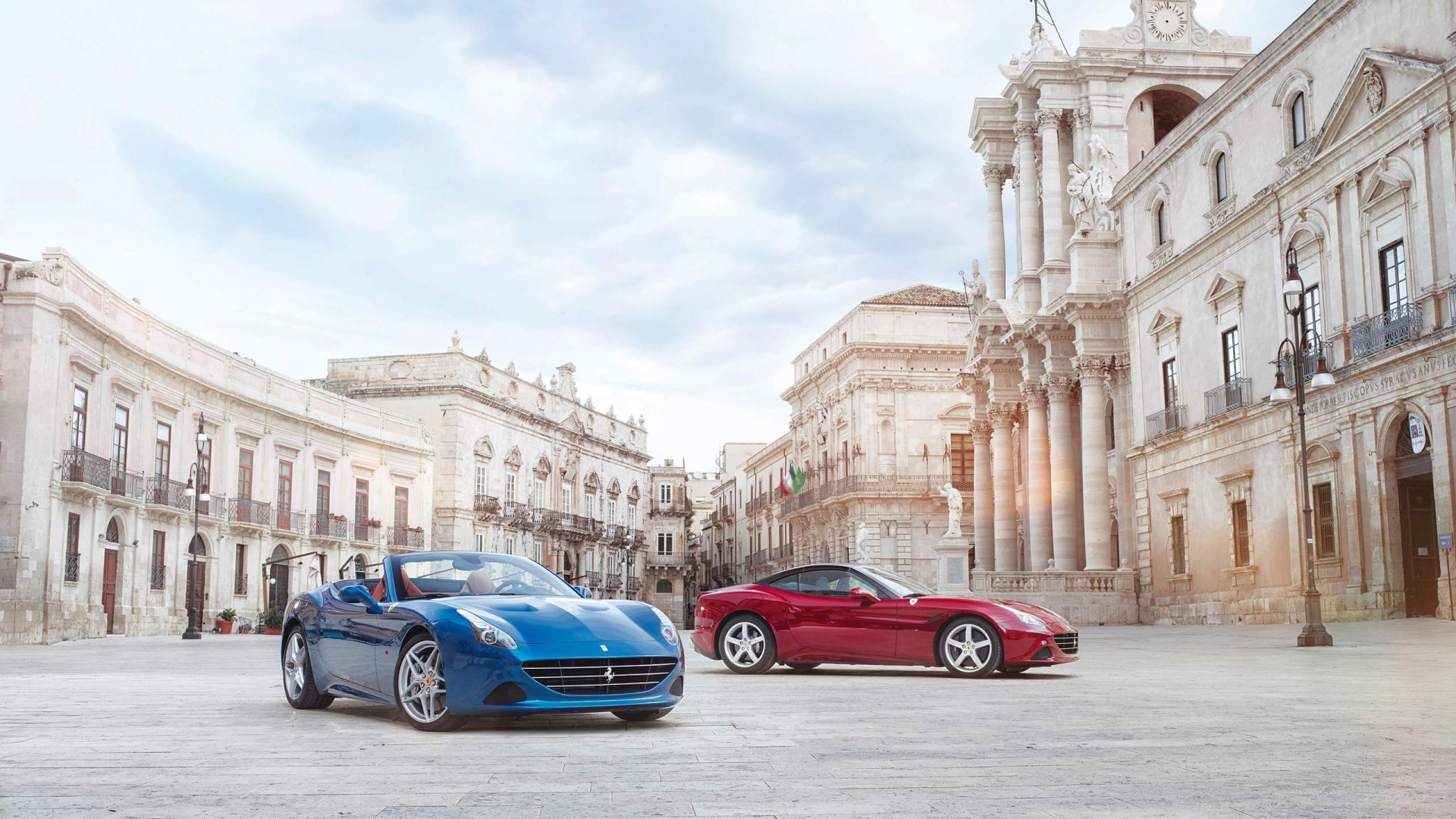 Blue and Red Ferrari California T cars in a European square HD Wallpaper