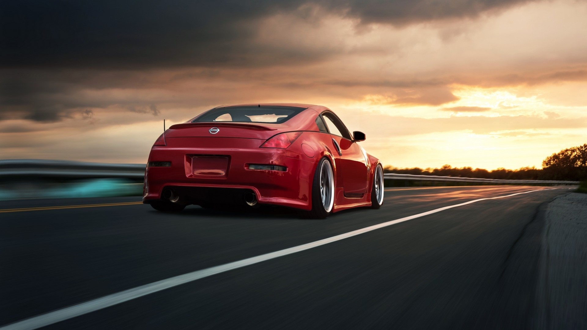Red Nissan 350z driving on a road at sunset HD Wallpaper