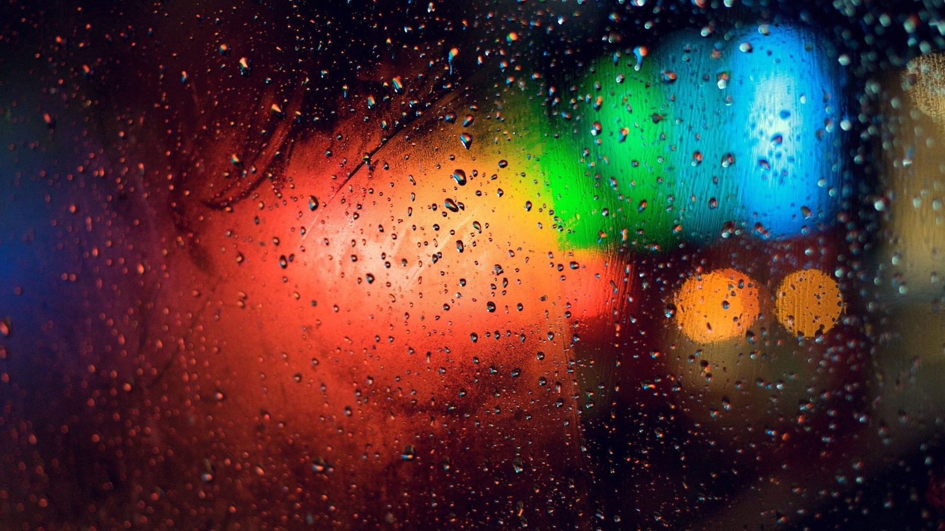 Raindrops on a window with colorful bokeh lights HD Wallpaper