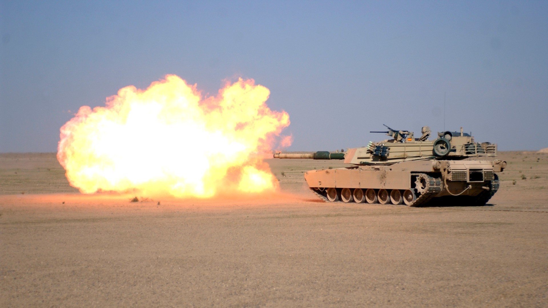 Tank firing a projectile in a desert HD Wallpaper