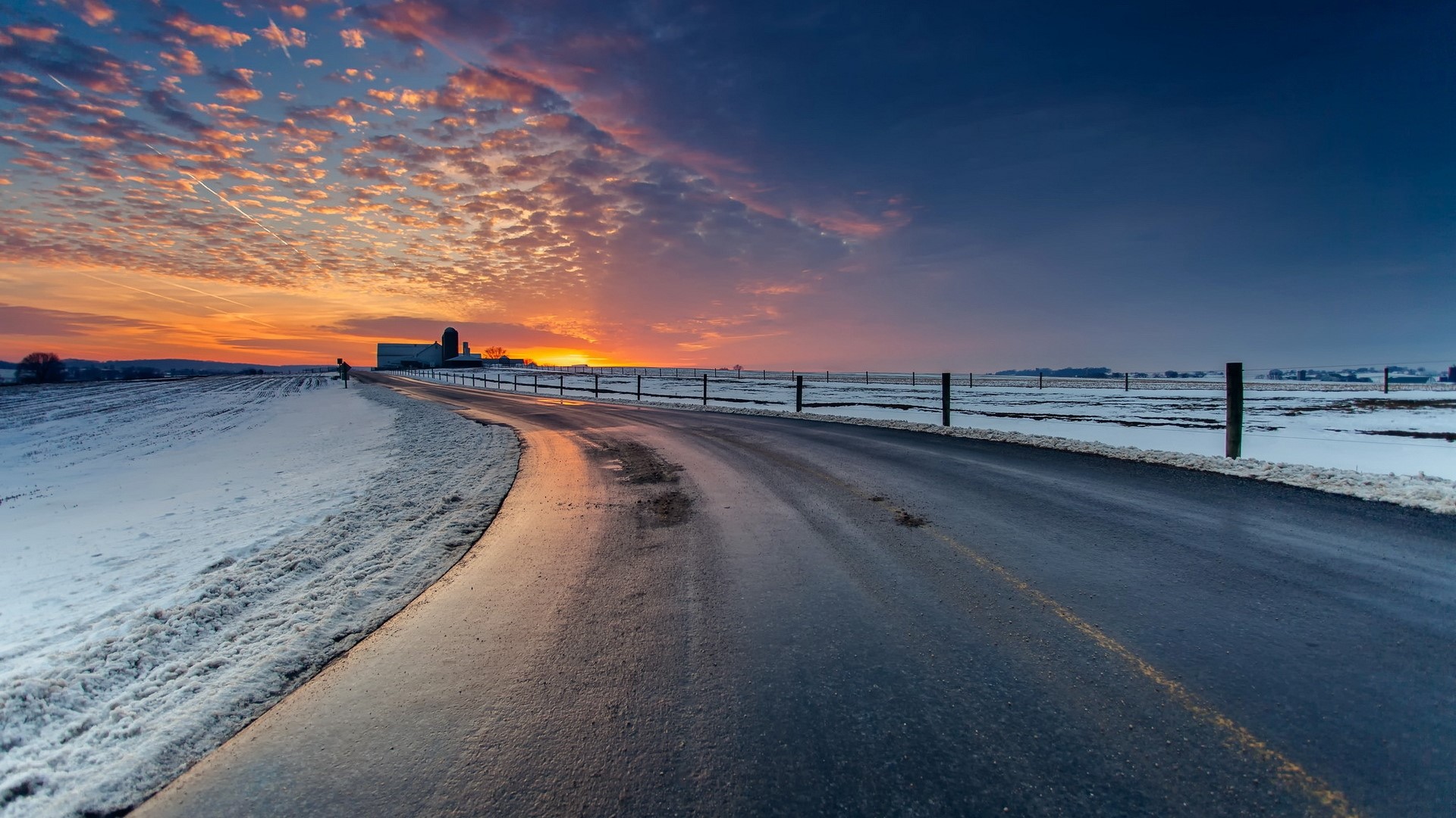 Road through snowy landscape at sunset HD Wallpaper