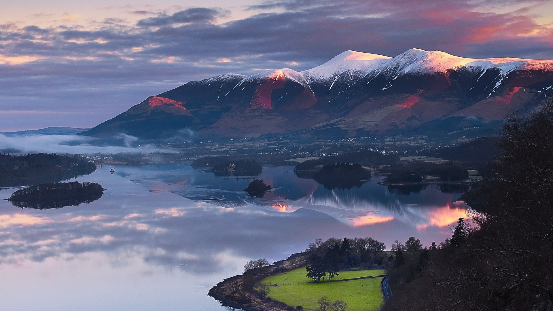 Snowy mountain peaks reflected in a lake at sunrise HD Wallpaper
