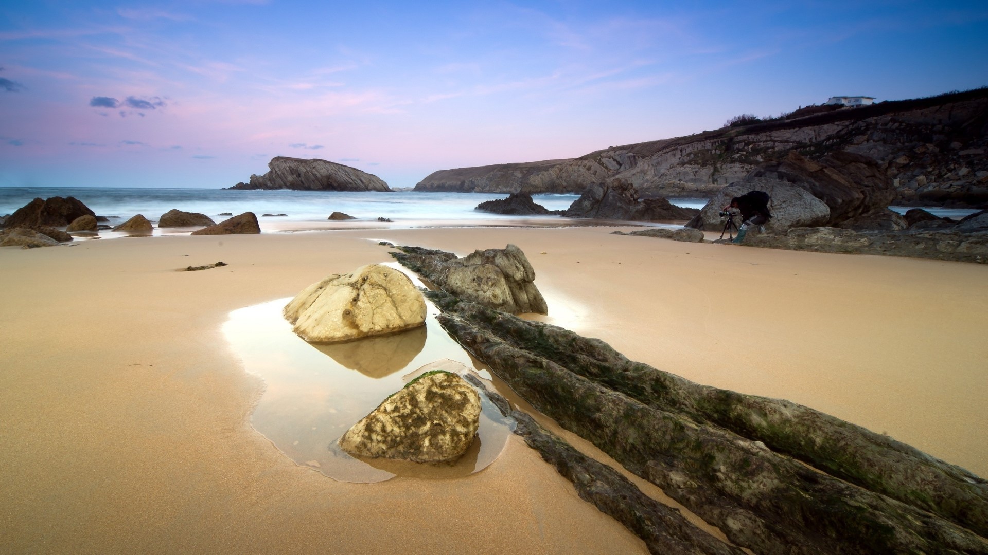 Beach with rocks and ocean at sunset HD Wallpaper