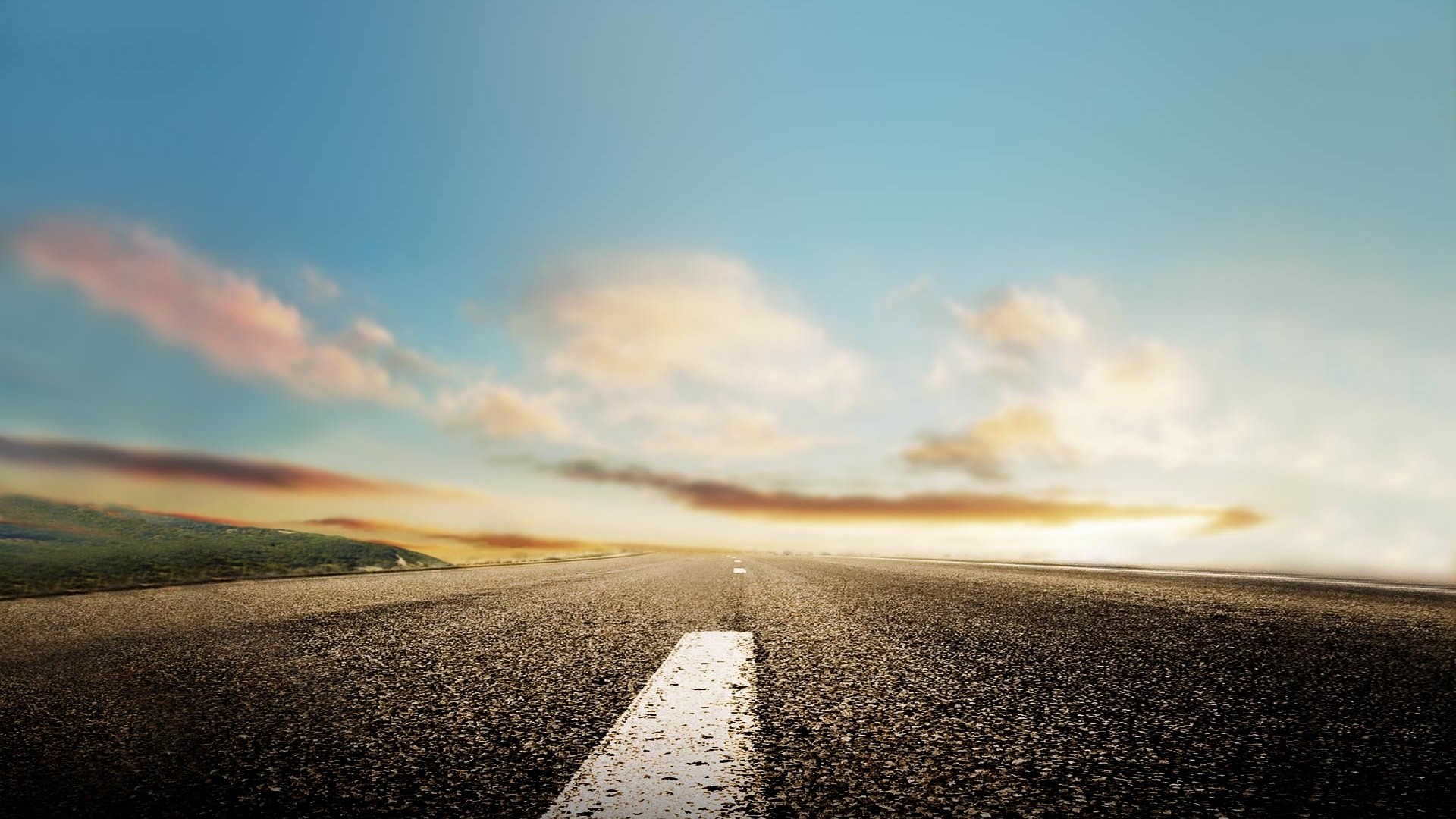 Road stretching into the horizon under a cloudy sky HD Wallpaper