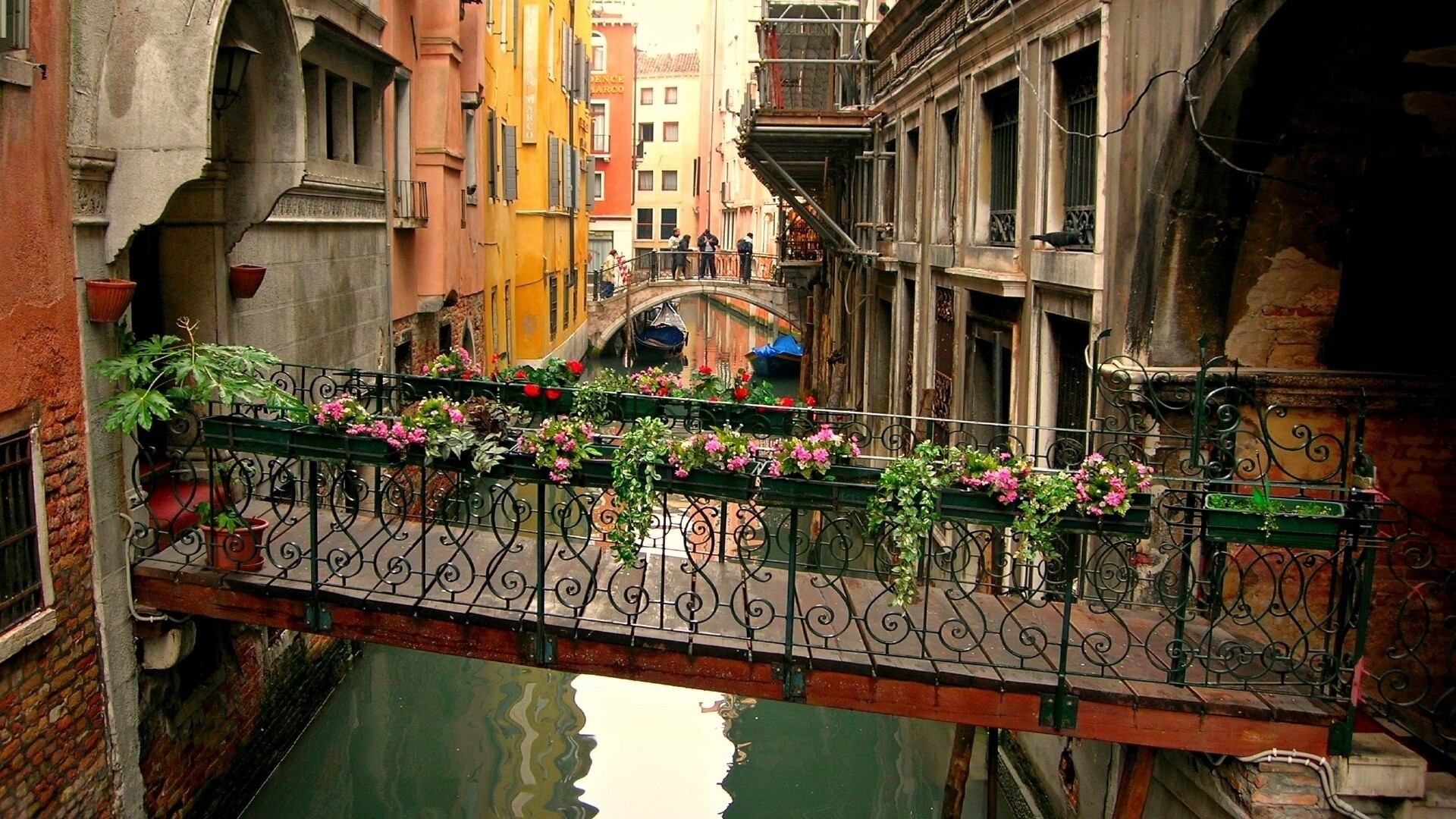 Flower-covered footbridge over a canal in Venice, Italy HD Wallpaper