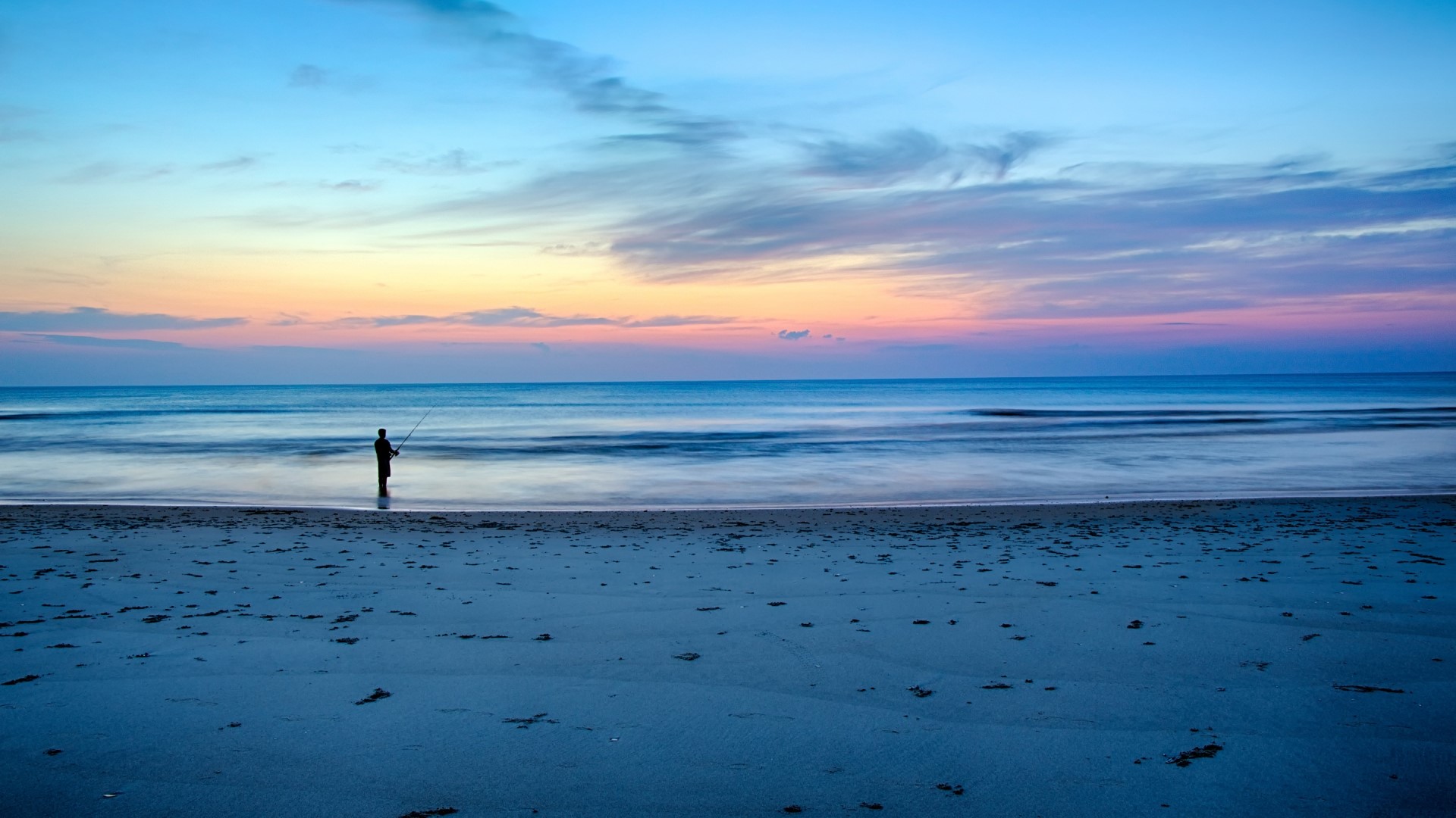 Fisherman on beach at sunrise in Corolla, North Carolina HD Wallpaper