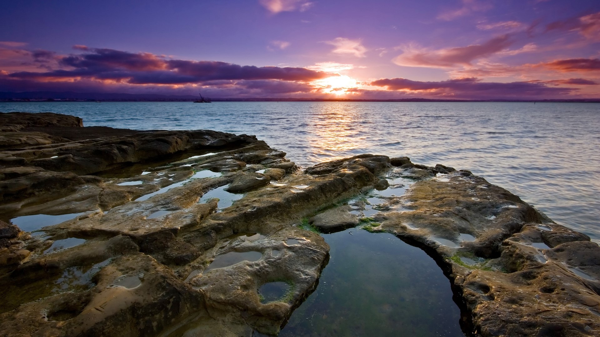 Sunset over the ocean with rocky shore HD Wallpaper