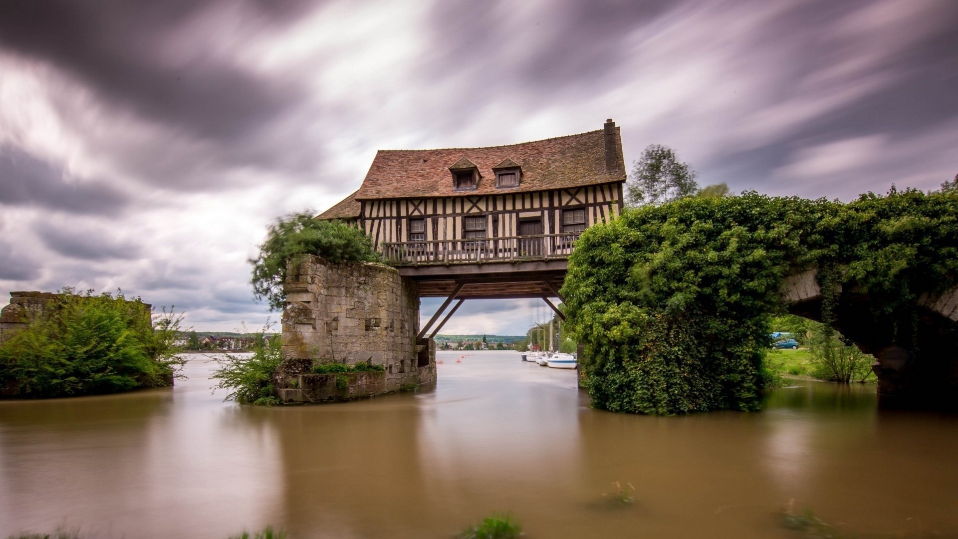Half-timbered house on a bridge over a river in France HD Wallpaper