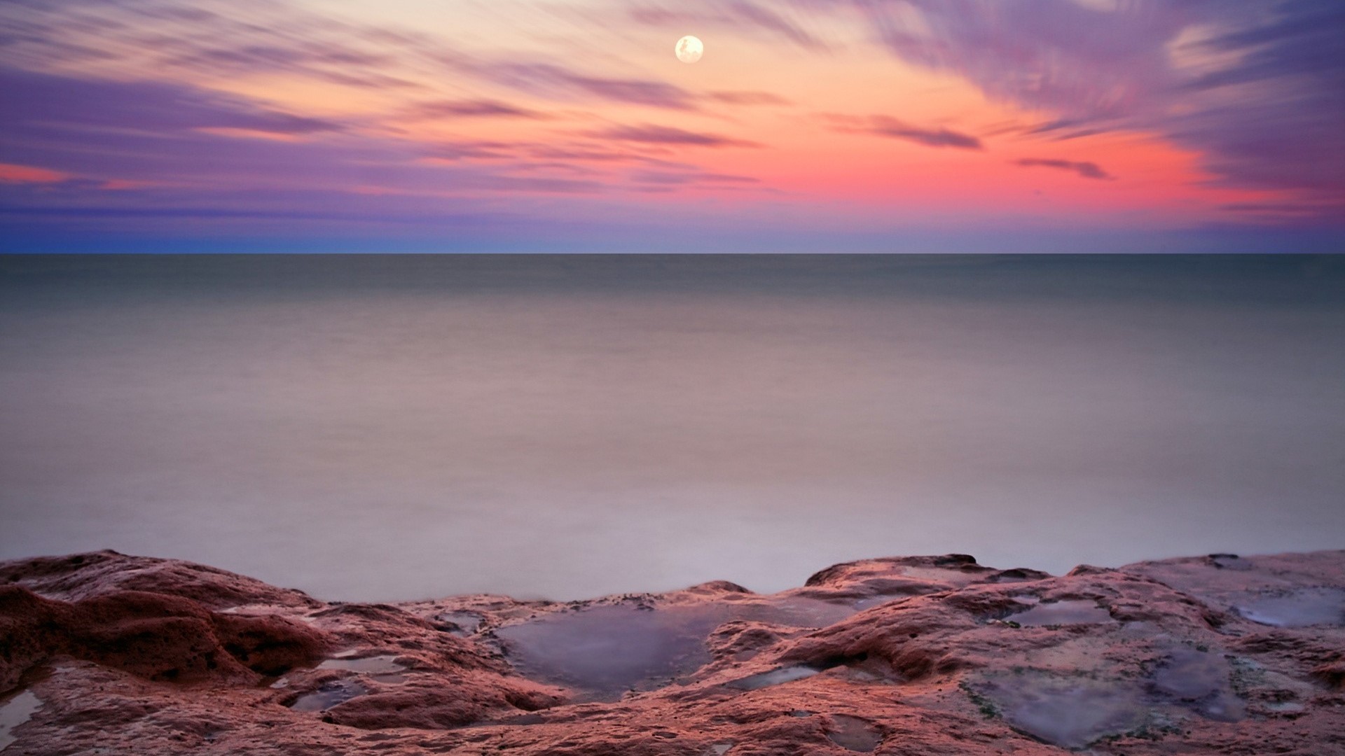 Moonlit Sky Over Calm Sea and Rocky Shore HD Wallpaper