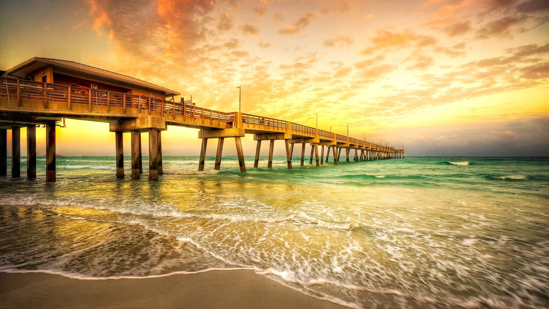 Ocean pier at sunrise with waves HD Wallpaper