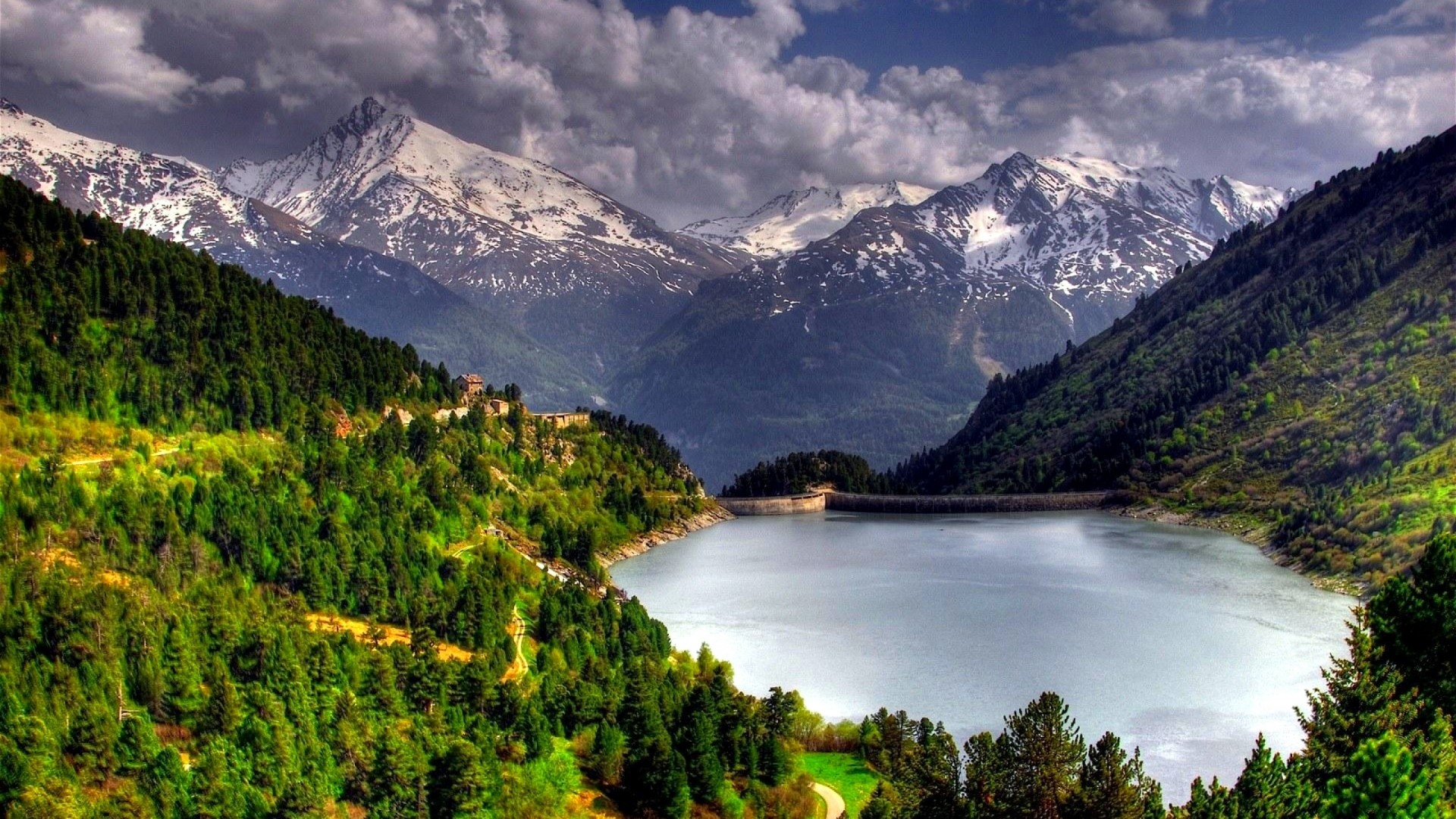Lake and snow-capped mountains with green forest HD Wallpaper