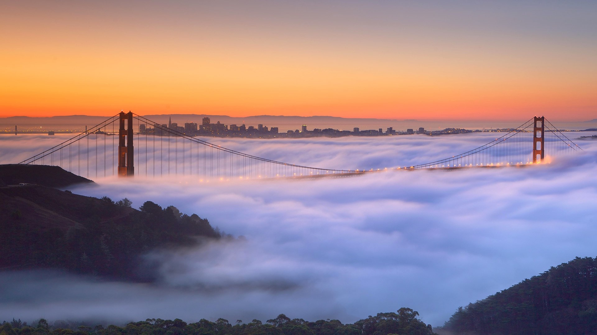 Golden Gate Bridge shrouded in fog at sunrise HD Wallpaper