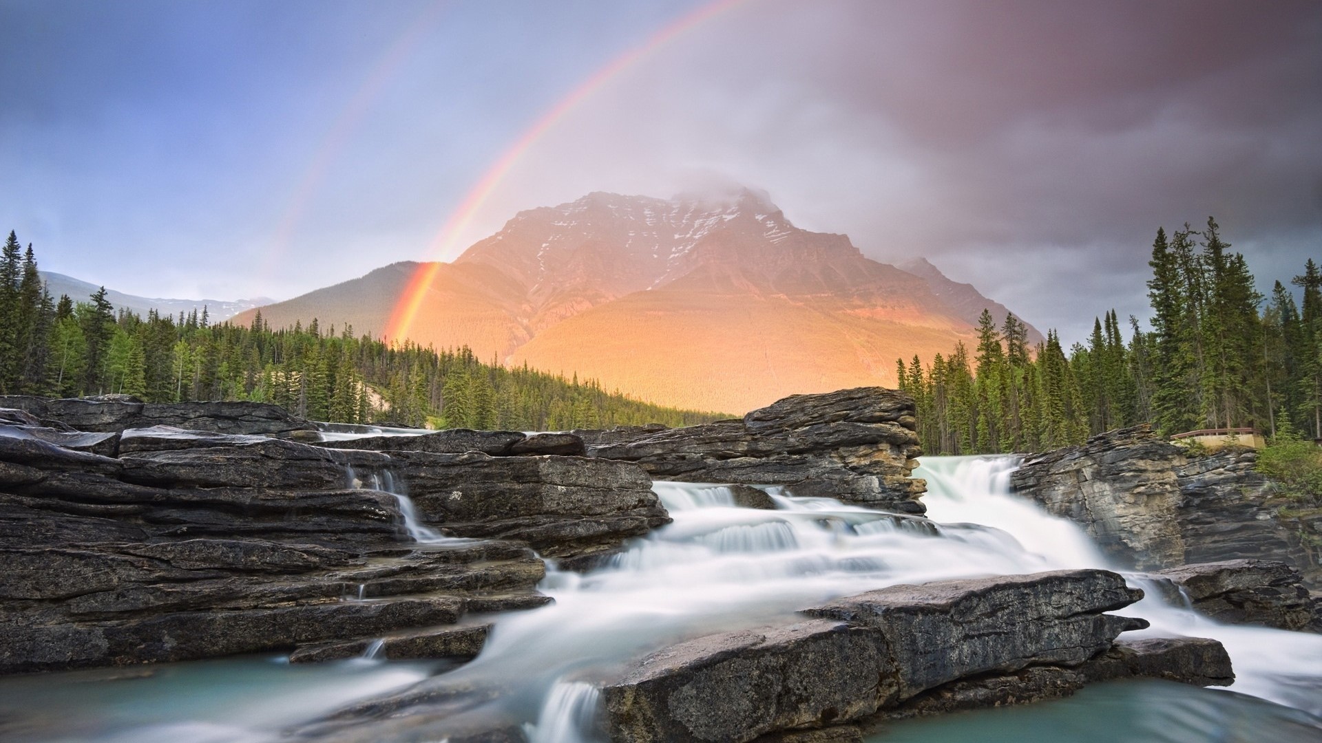 Rainbow over a mountain and waterfall HD Wallpaper