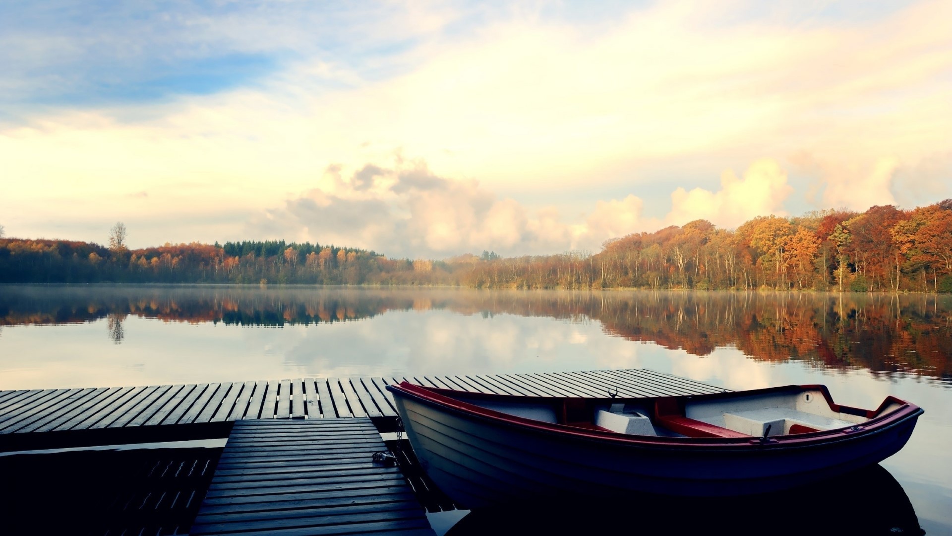 Boat on a dock by a lake during autumn HD Wallpaper