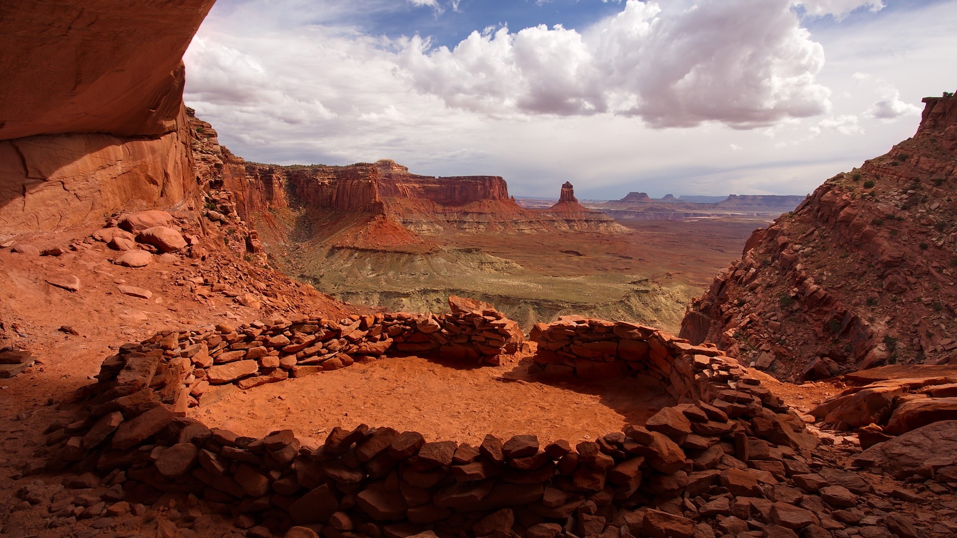 Ancient ruins in a desert canyon landscape HD Wallpaper