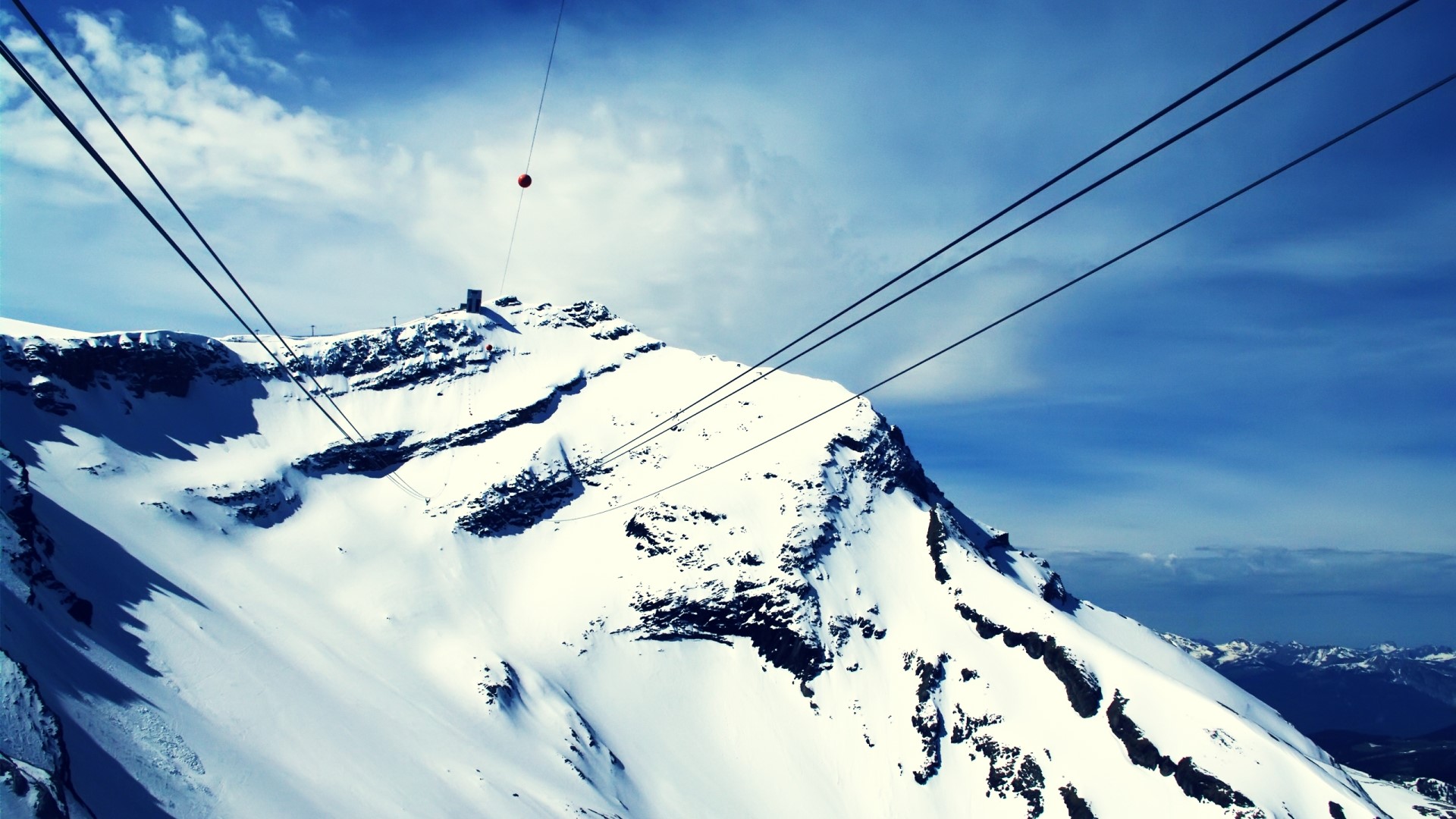 Snowy mountain peak with cable car lines HD Wallpaper