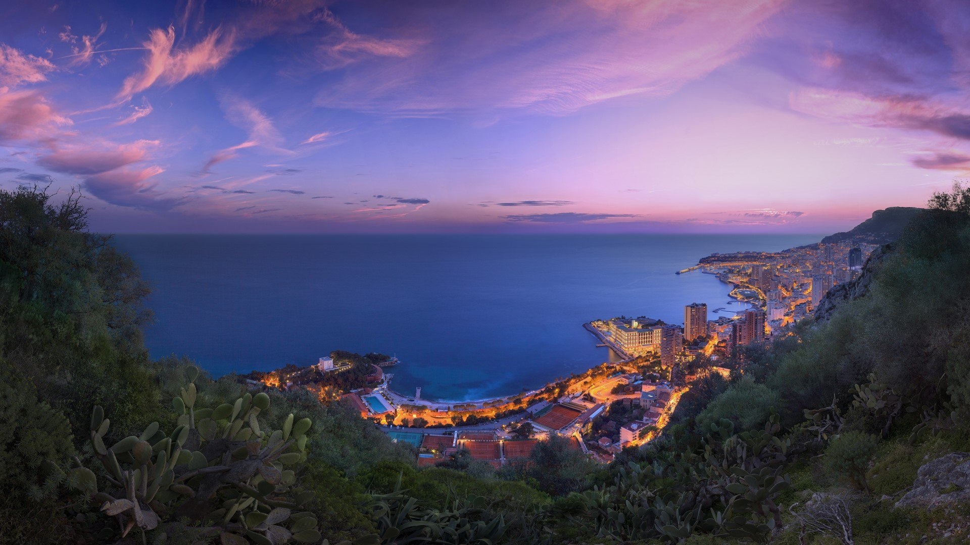 Monaco cityscape at sunset with purple clouds over the sea HD Wallpaper