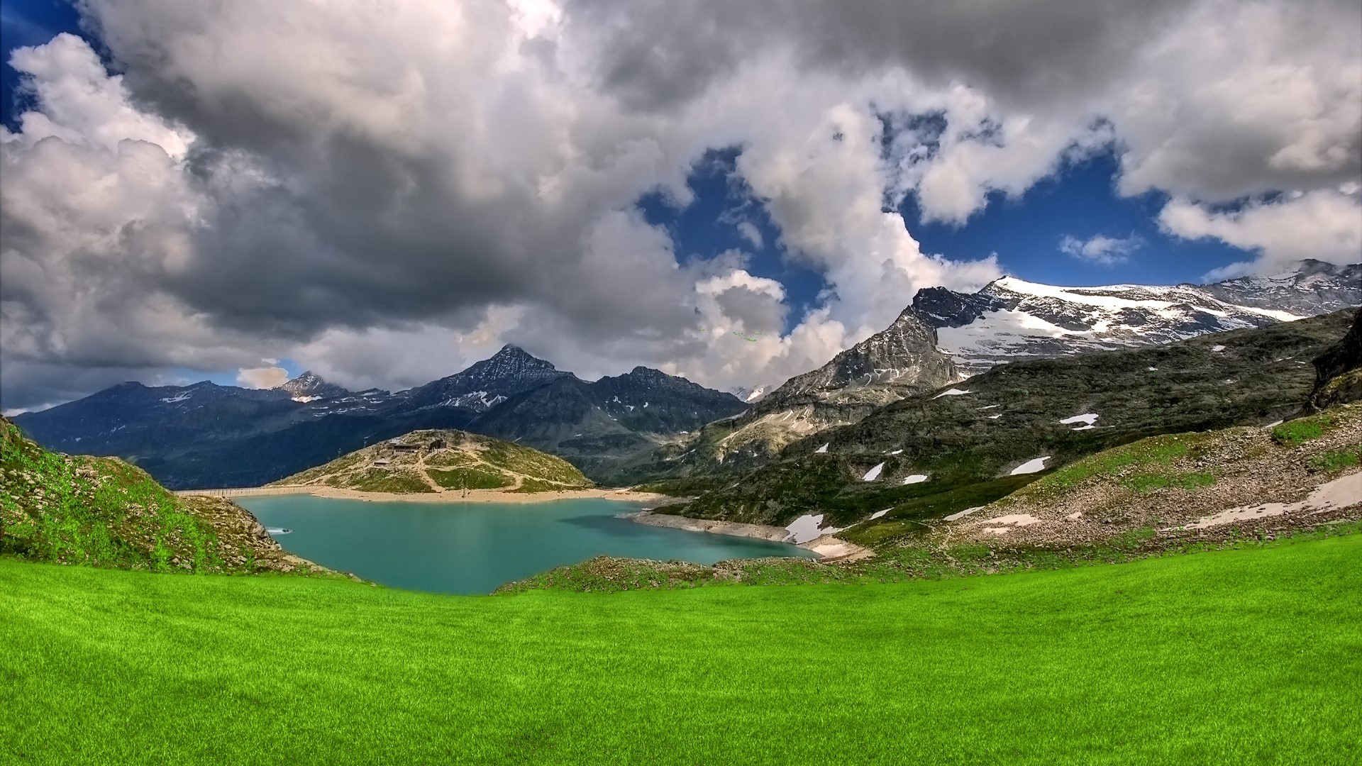 Green grass mountain landscape with lake and clouds HD Wallpaper
