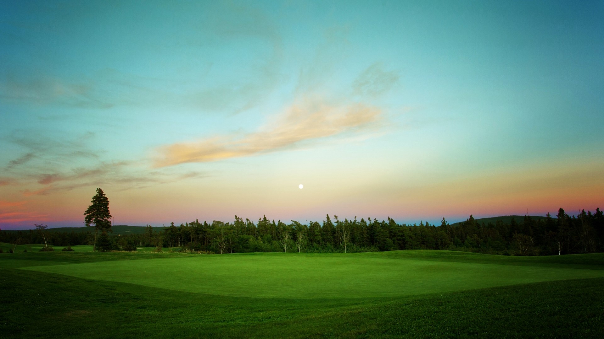 Golf course at sunset with moon HD Wallpaper