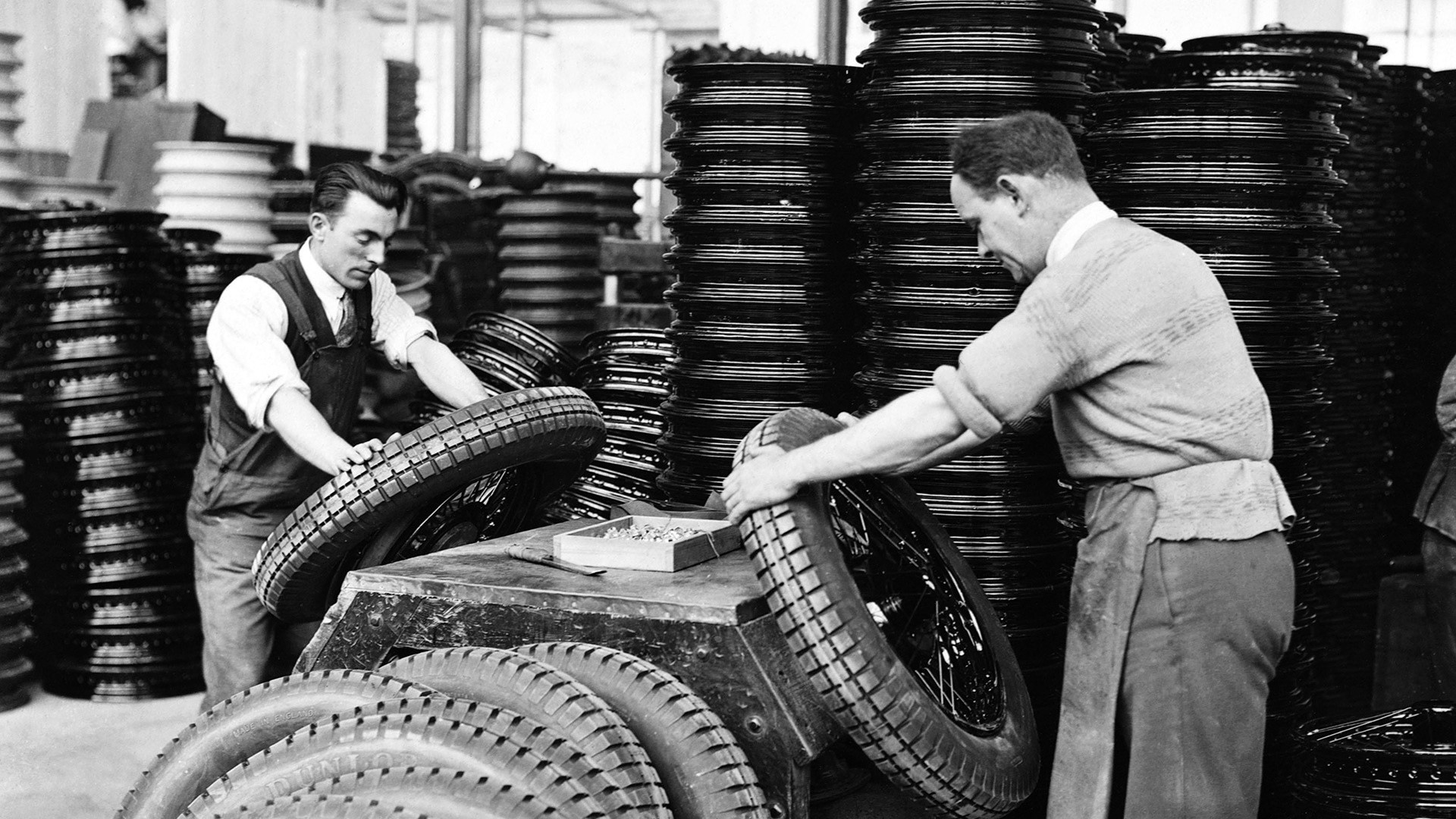 Workers Assembling Tires in a Factory HD Wallpaper