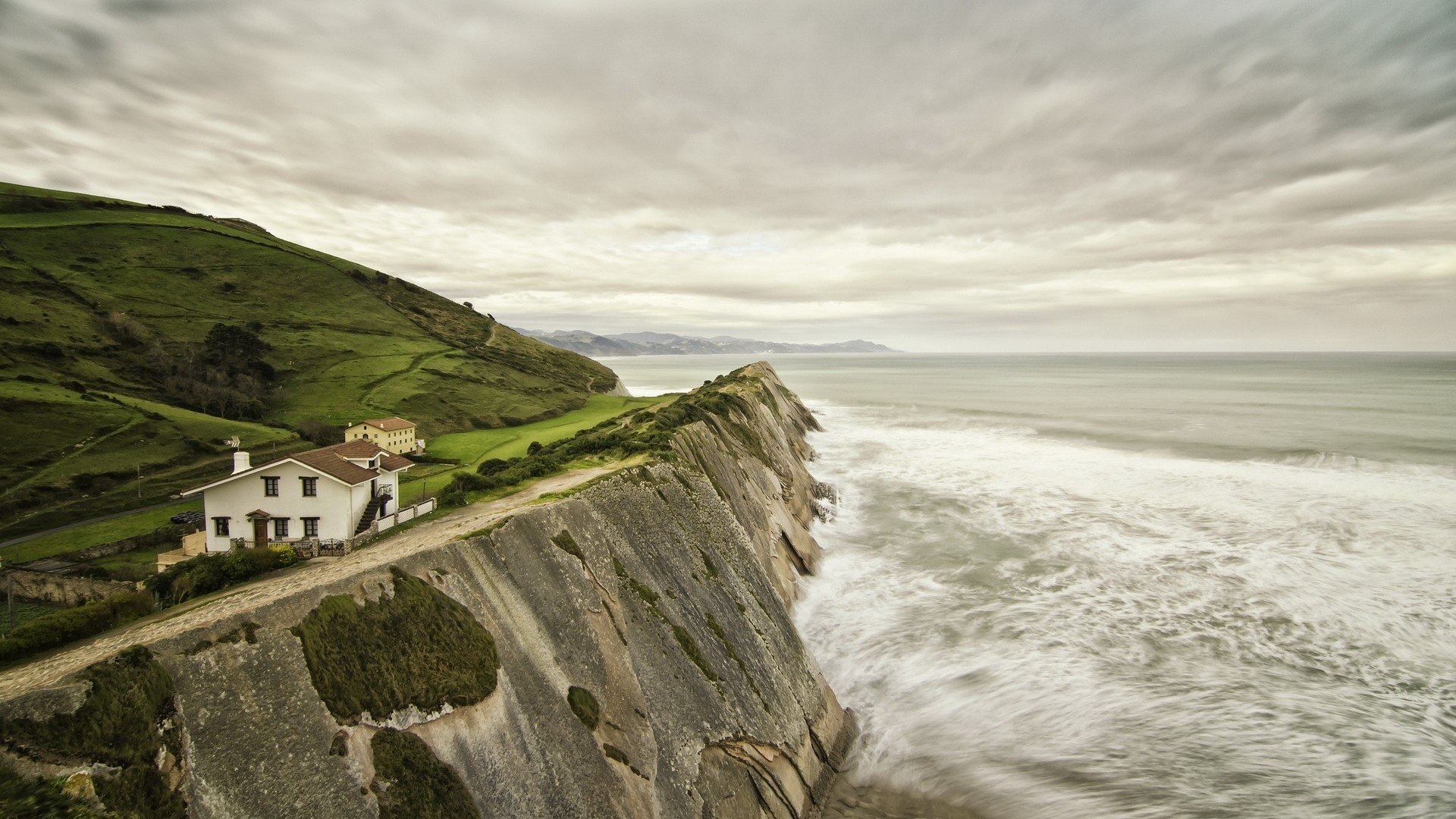 House on a cliff overlooking the ocean HD Wallpaper