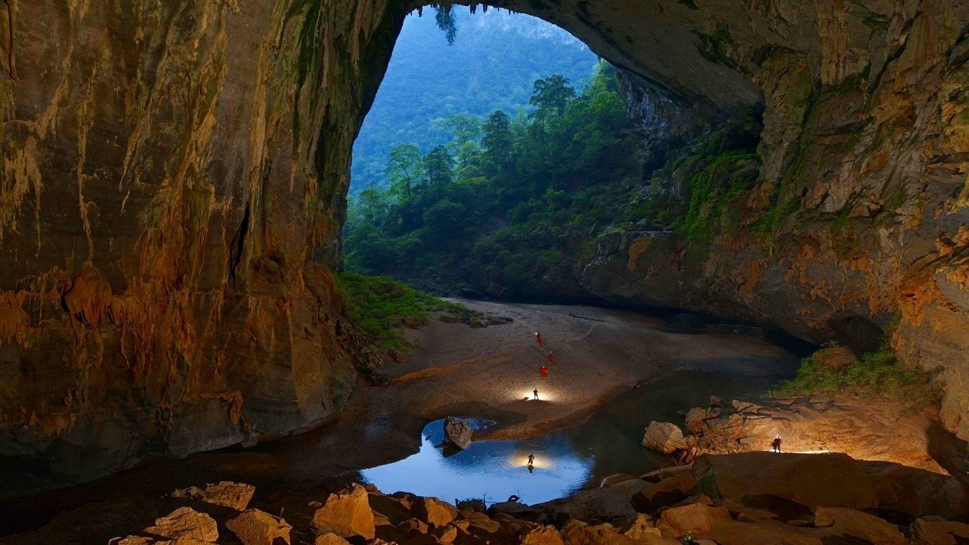 Giant Cave with River and Forest Entrance HD Wallpaper