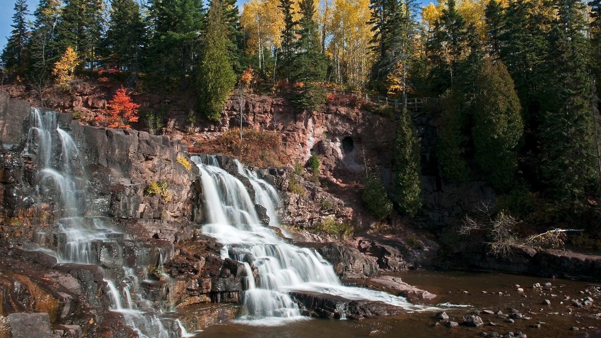 Waterfall in a forest during autumn HD Wallpaper